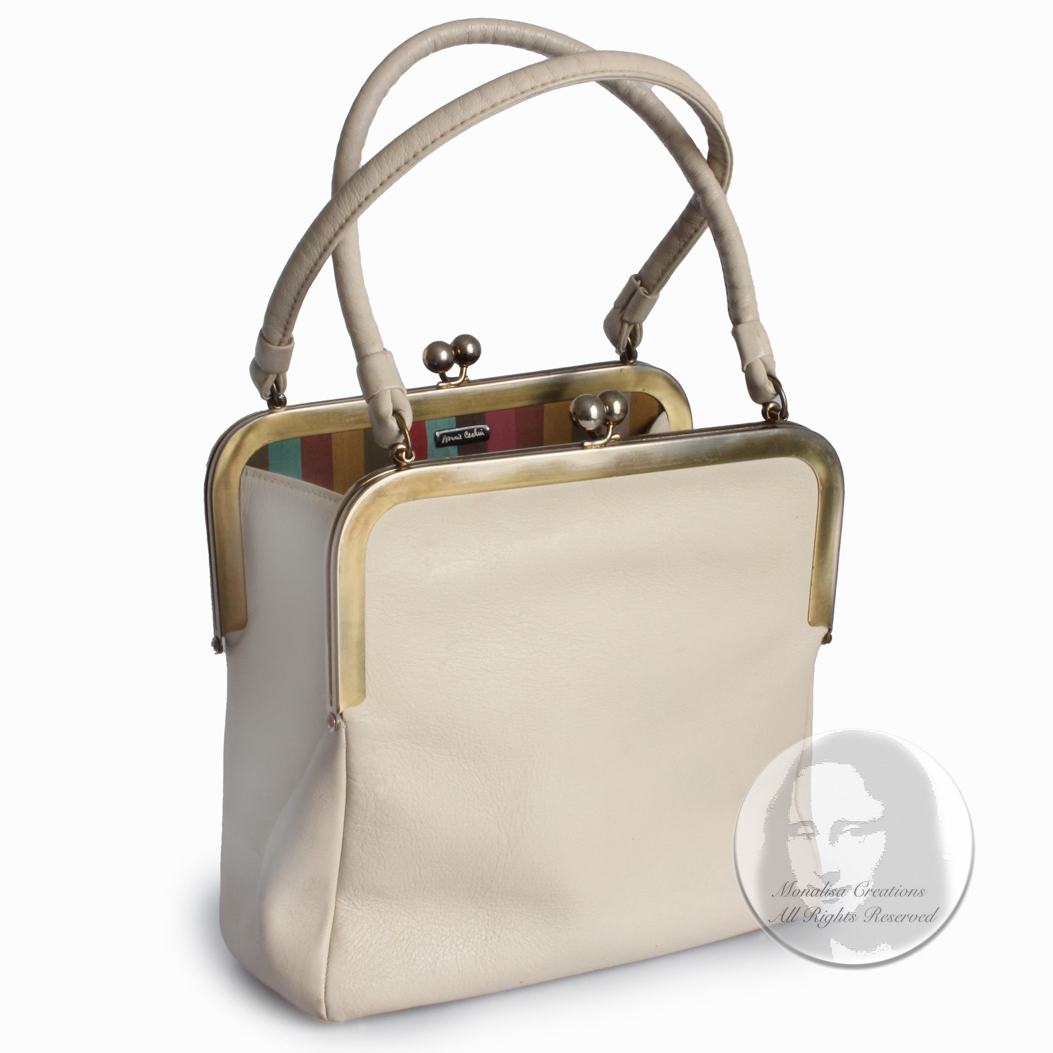 Incredibly rare Bonnie Cashin for Coach double kiss lock bag (aka double header) with rolled handles, likely made in the 1960s.  Made from bone-colored leather, it features two oversized kiss lock pockets and one open center compartment, all lined