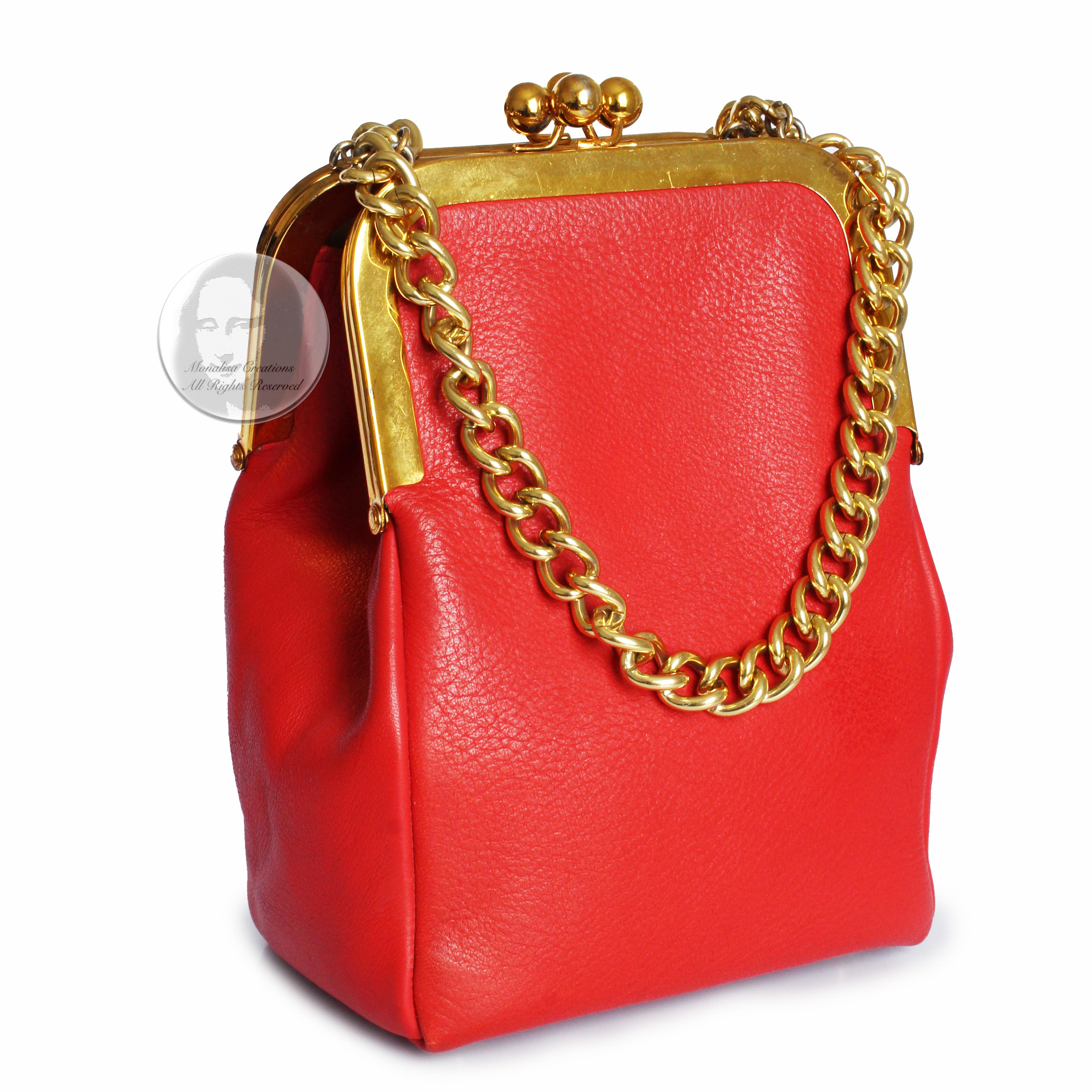 Authentic, preowned, vintage 60s Bonnie Cashin for Coach Double Kiss Lock bag. A chic vintage bag in a hard-to-find color! Made from coral-hued red leather, it's lined in Cashin's signature striped fabric and features double chain straps and gold