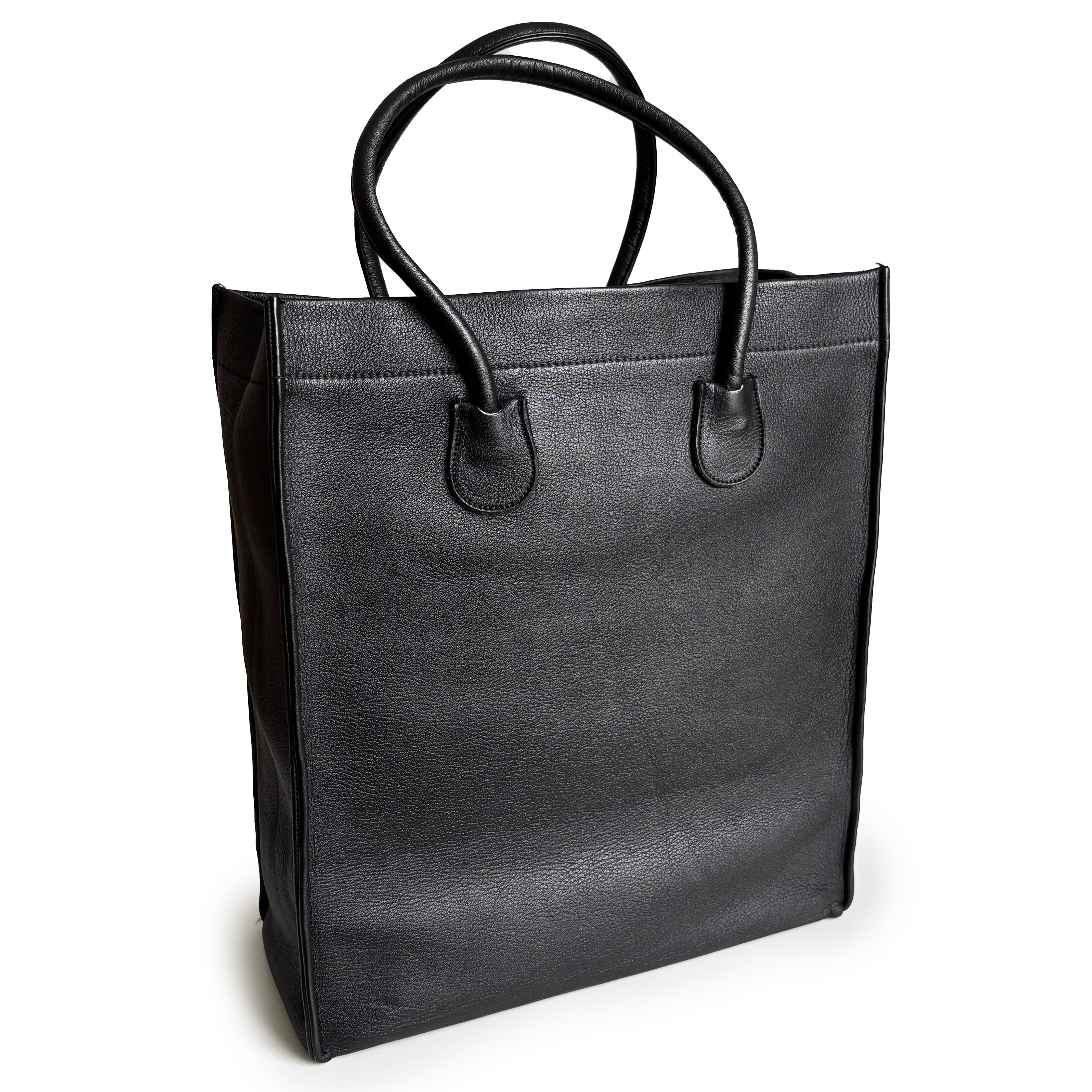 This is an authentic, vintage Bonnie Cashin for Coach Classic Shopping Tote, aka The Large Shopping Tote, dating to the mid 1960s. Crafted from sturdy crushed black cowhide leather, this minimalist yet functional bag embodies Cashin’s signature