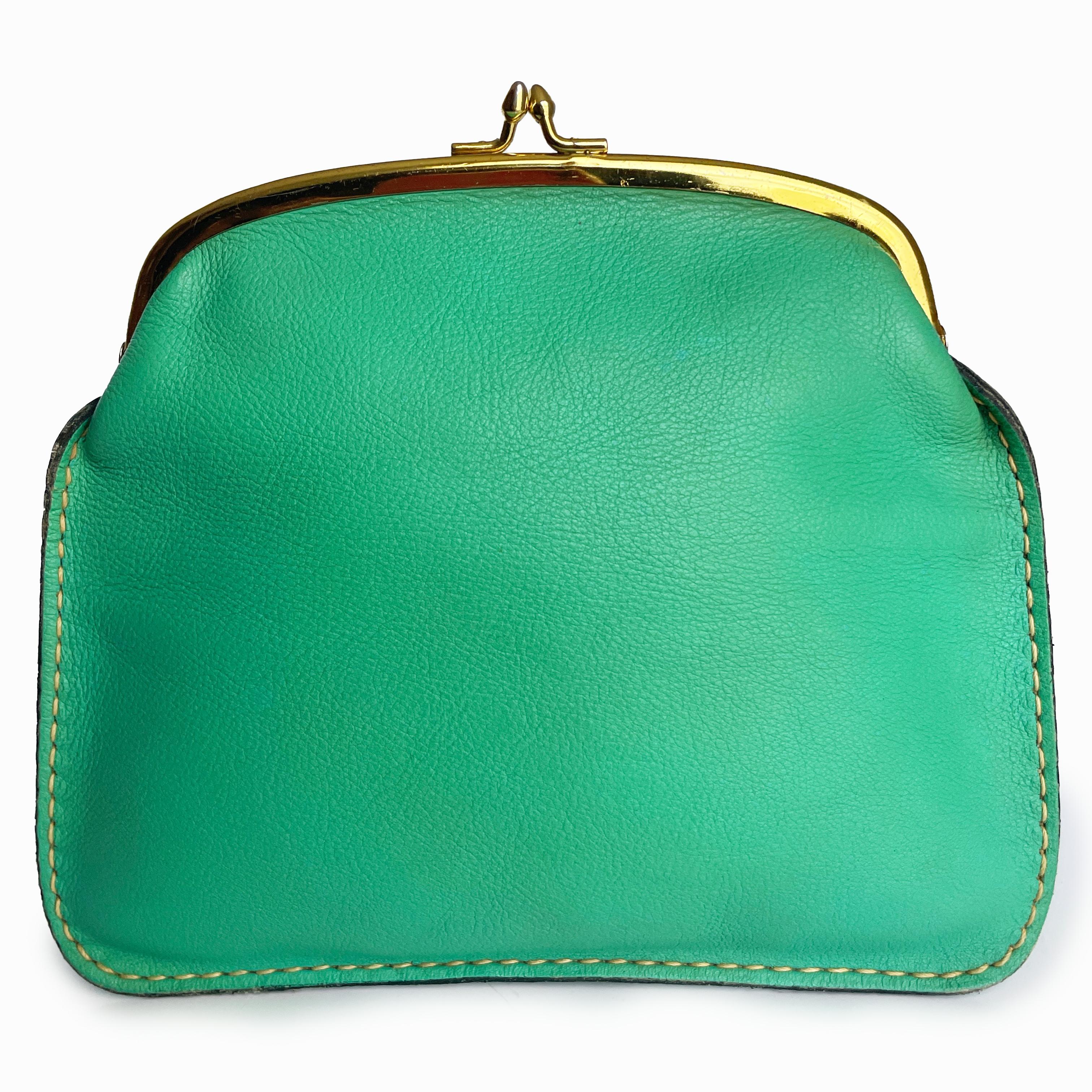 Bonnie Cashin for Coach 'foldover purse' or clutch bag, part of Bonnie's Cashin Carry accessories collection and likely made in the late 1960s.

Made from mint green leather with white contrast exterior stitching, this vibrant little bag fastens