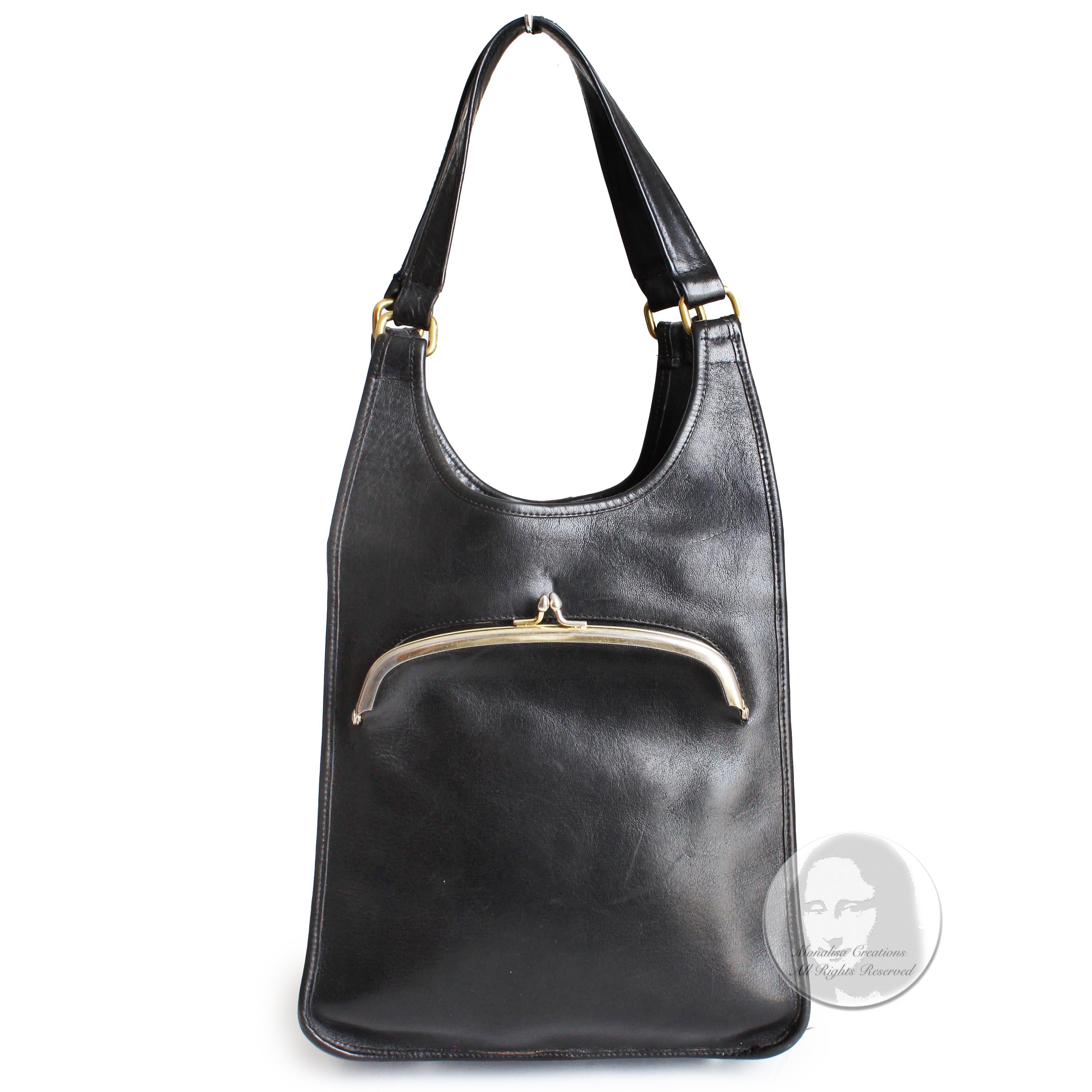 Preowned, vintage Bonnie Cashin for Coach kiss lock tote bag, likely made in the 1960s. Made from black leather, it features a kiss lock coin purse in front, and an open main compartment that's lined in Bonnie's signature striped fabric with one