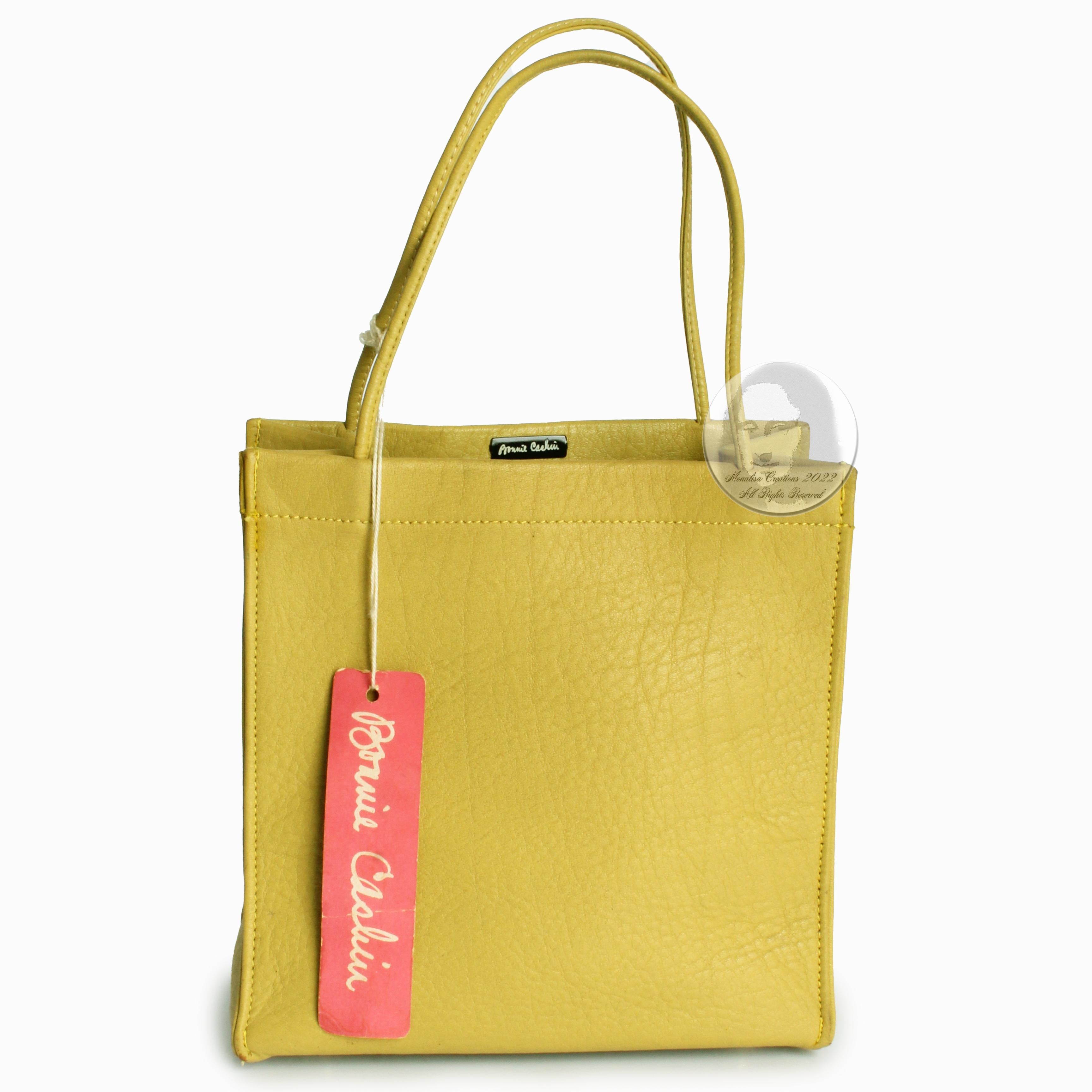 Looking for a ray of sunshine?  This preowned, vintage 60s Bonnie Cashin for Coach mini tote bag should do the trick! Made from 'Mimosa' leather (green with yellow undertones), it has four metal feet at the bottom and is lined in Cashin's signature
