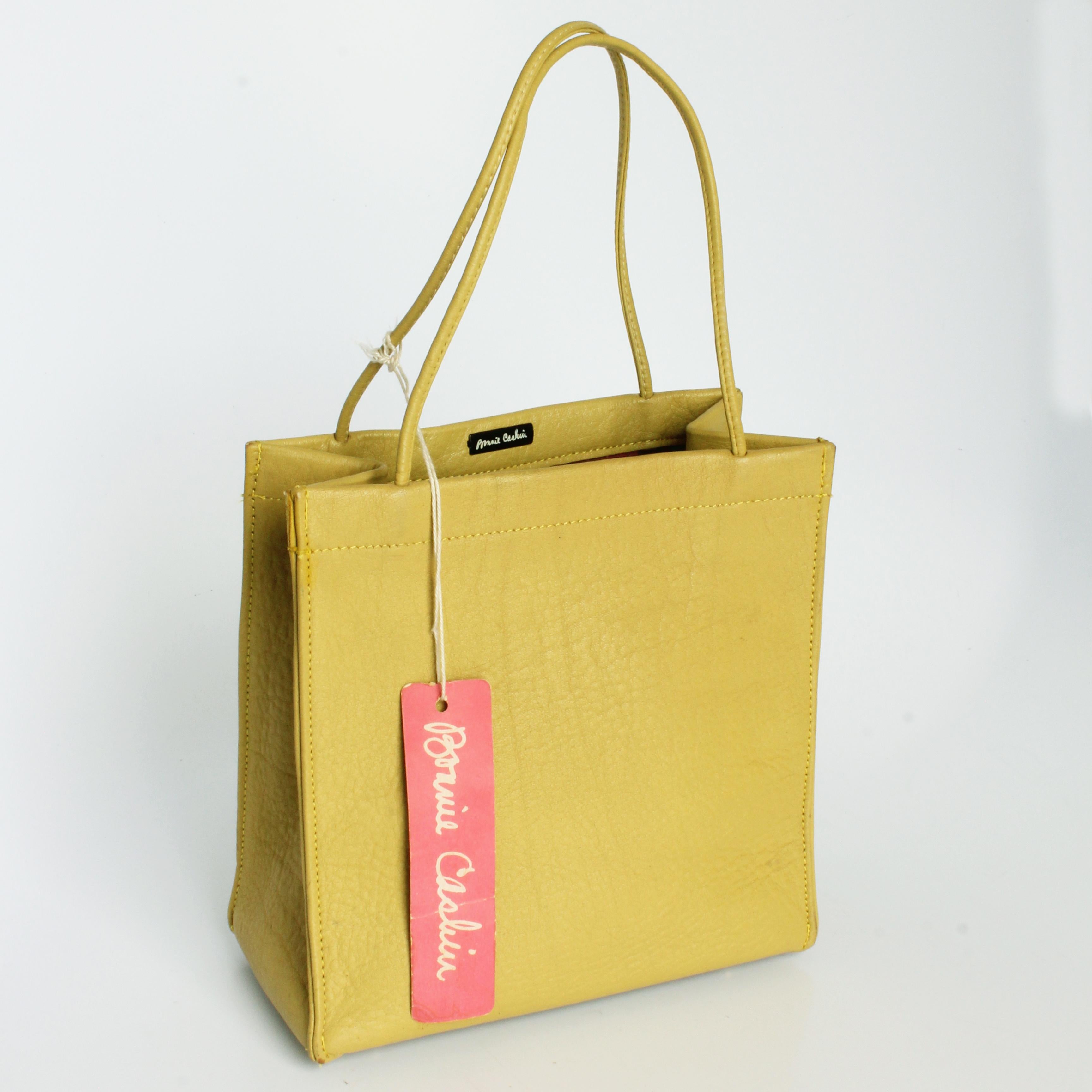 Looking for a ray of sunshine?  This preowned, vintage 60s Bonnie Cashin for Coach mini tote bag should do the trick! Made from 'Mimosa' leather (green with yellow undertones), it has four metal feet at the bottom and is lined in Cashin's signature