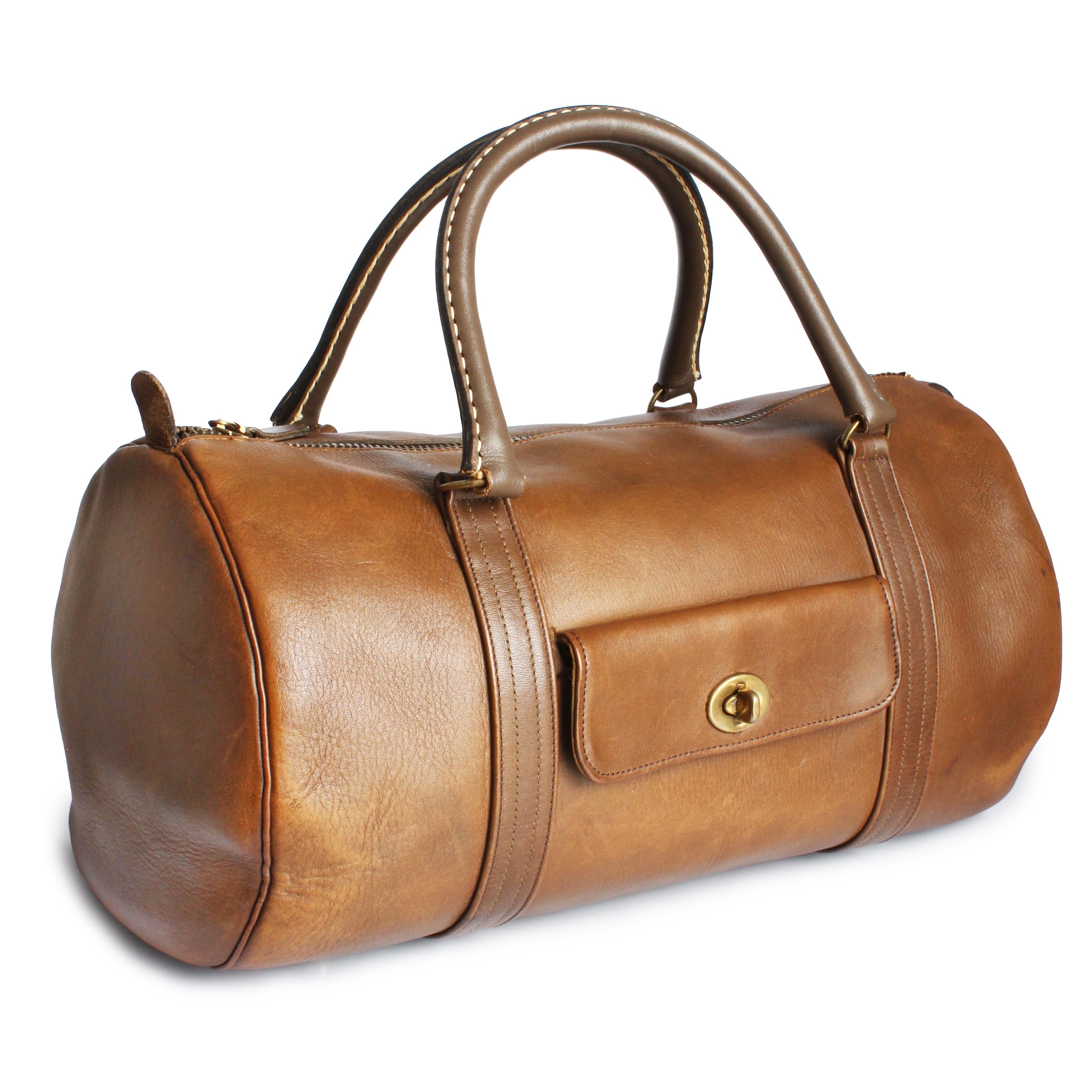 Authentic, preowned, vintage and super-rare Bonnie Cashin for Coach Safari DuffleBag Tote, likely made in the 60s.   Made from a brown-hued tan leather exterior, it features turn lock patch pockets on each side and double handles. The main
