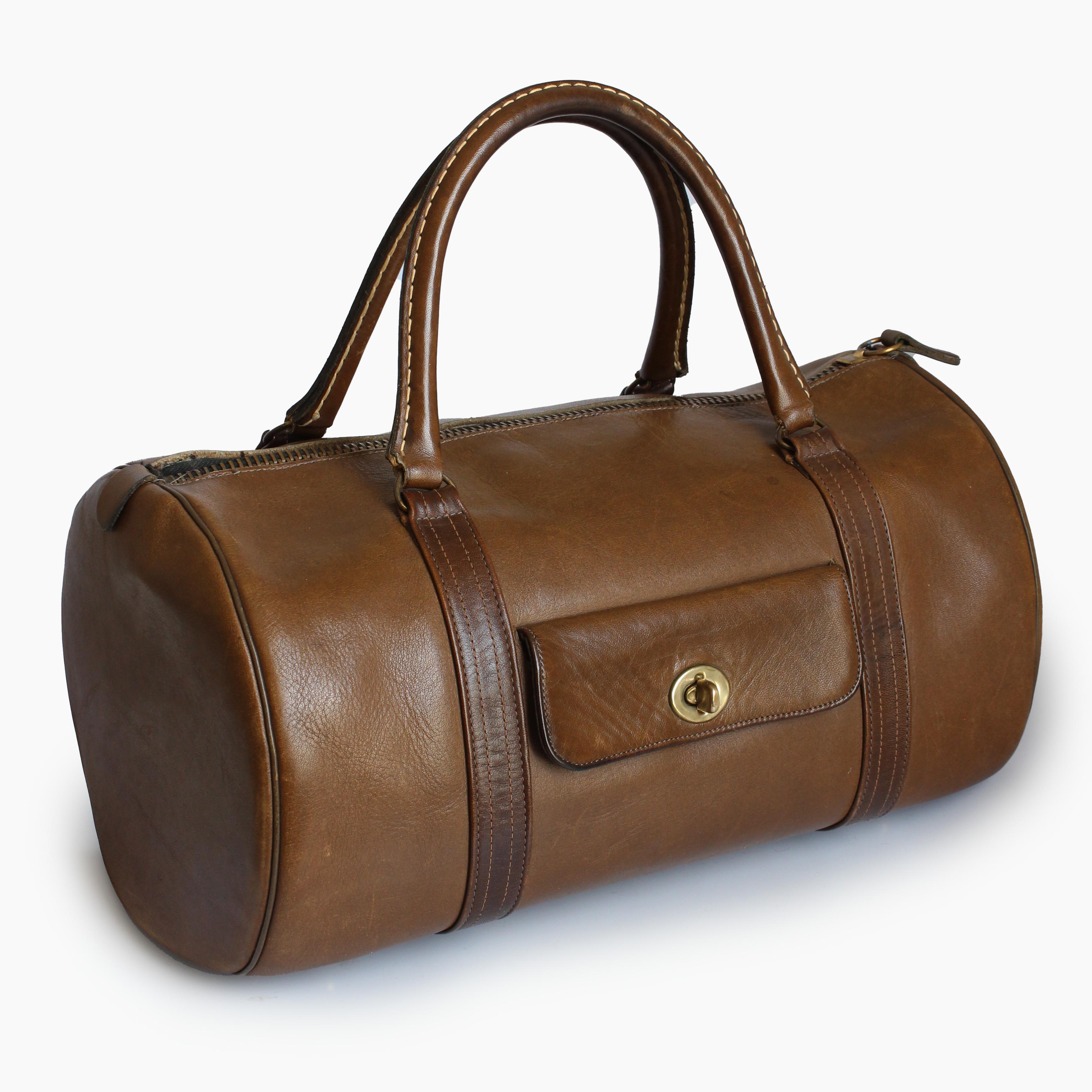 This incredibly rare bag was designed by Bonnie Cashin for Coach Leatherware, most likely in the late 60s, as part of her Safari collection (see image 2, where this style can be seen in a photo of Bonnie's studio). Made from a supple tabac brown