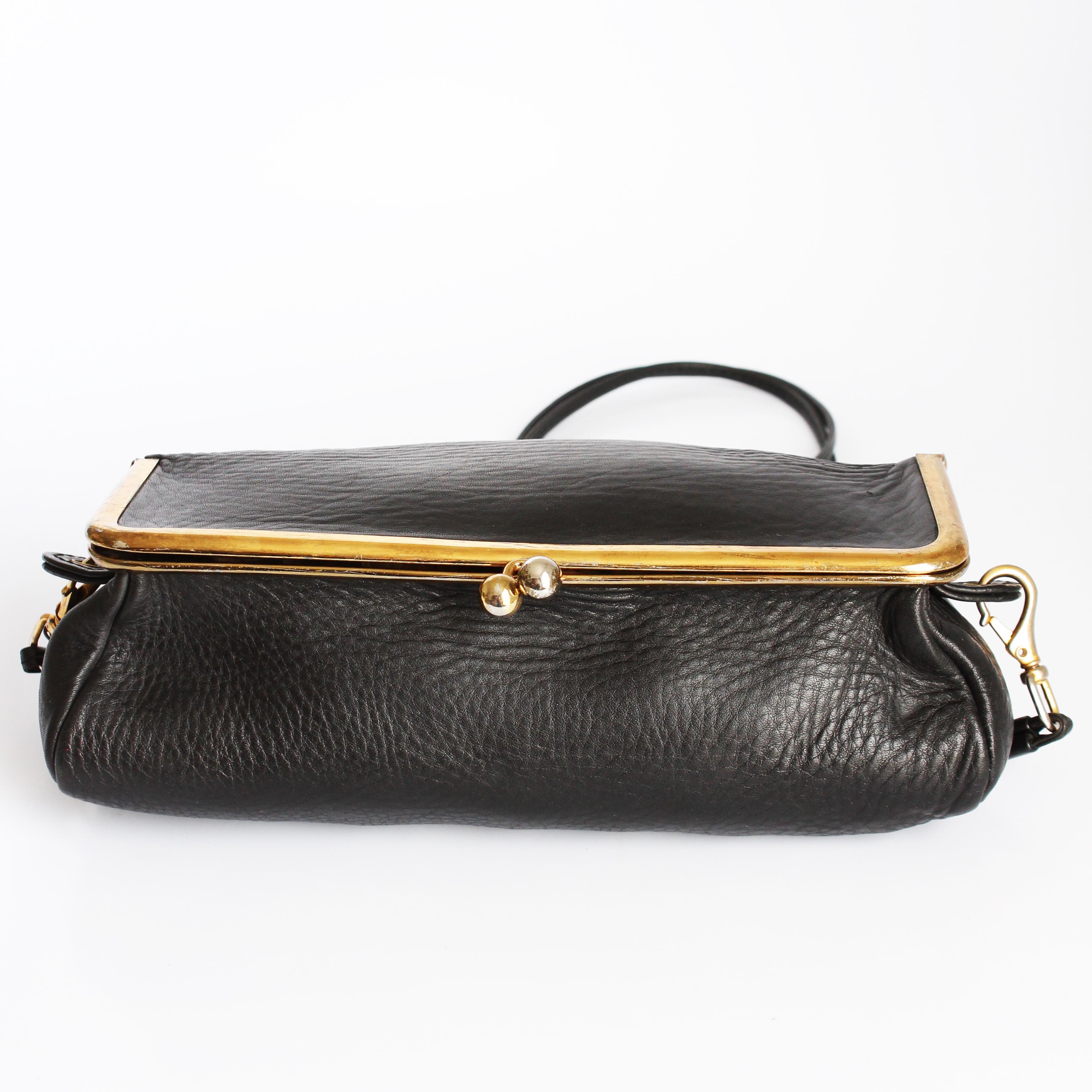 Preowned, vintage Bonnie Cashin for Meyers 'Box Bag' aka the bicycle purse, likely made in the mid 1970s.  Made from supple black pebbled leather, it fastens with a large kiss lock and features a removable double strand leather strap with brass push