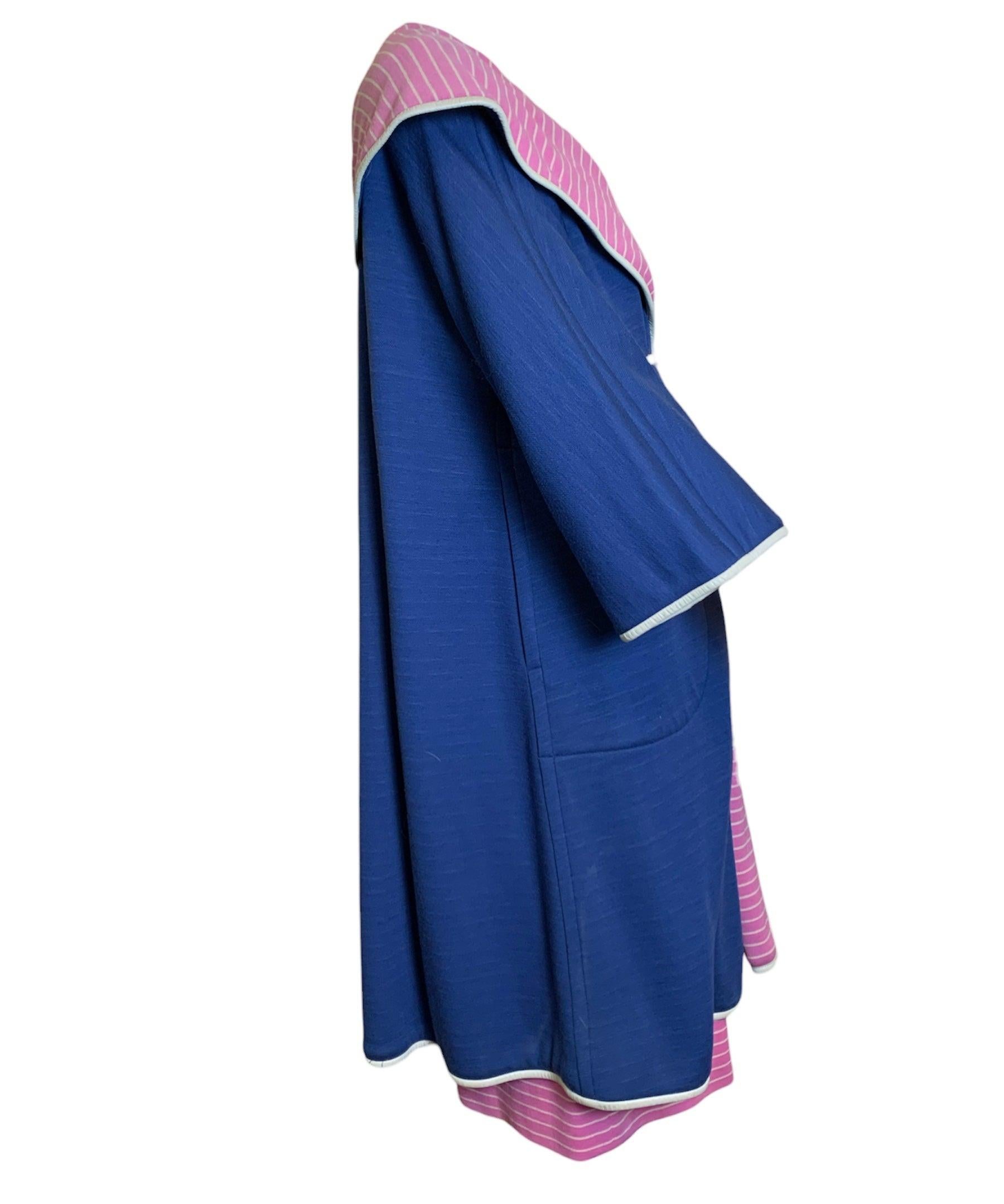 1960s  iconic American sportswear ensemble from Bonnie Cashin. Navy blue coat with bubblegum pink striped lining along with simple sheath style dress. All trimmed in designers signature leather. Mix and matchable  separates allow you to create