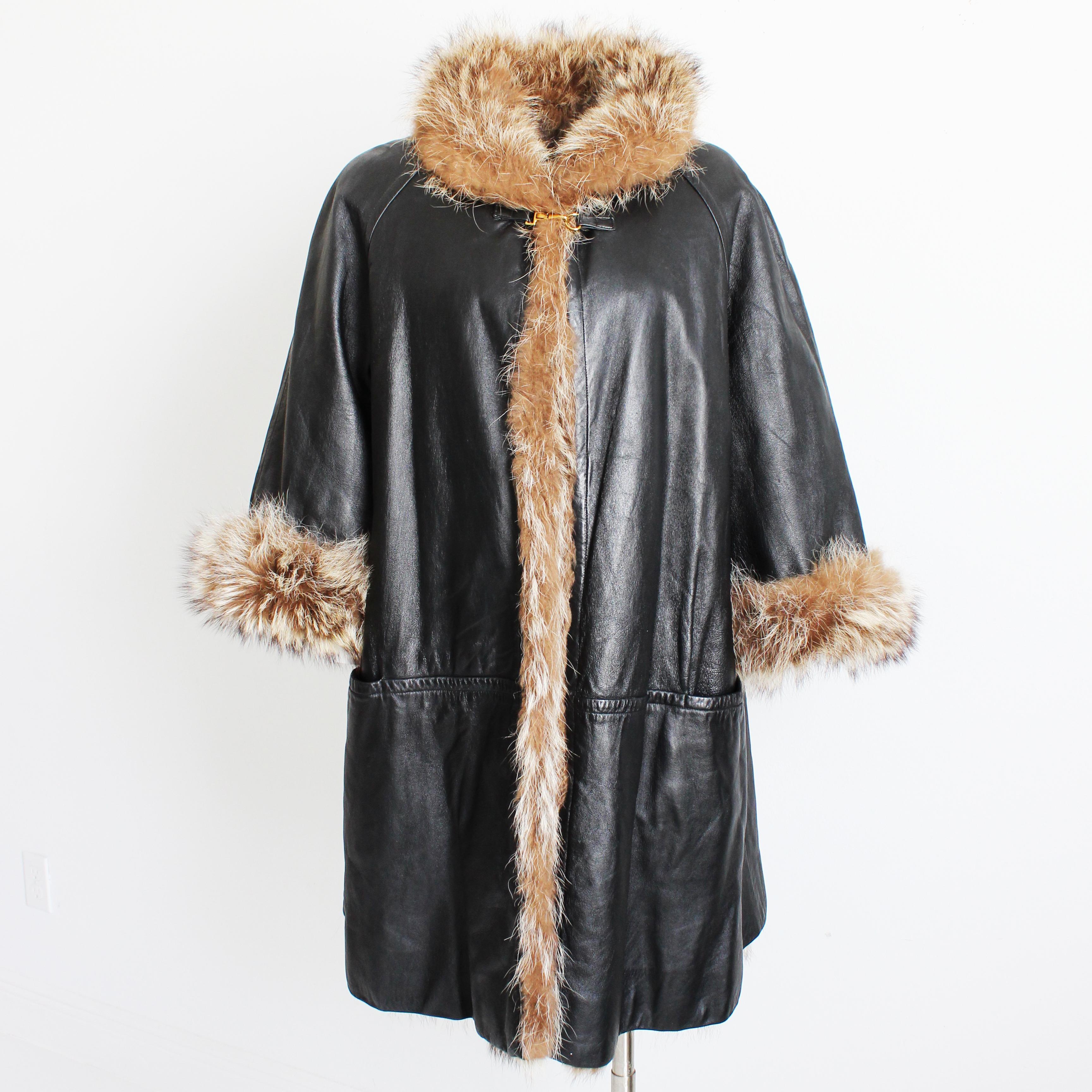 Vintage, preowned & authentic Bonnie Cashin for Sills Reversible Black Leather and Raccoon Fur Coat. 

This fabulous coat features gorgeous black leather on one side, soft raccoon fur on the other!  It fastens with a dog leash fastener at the collar
