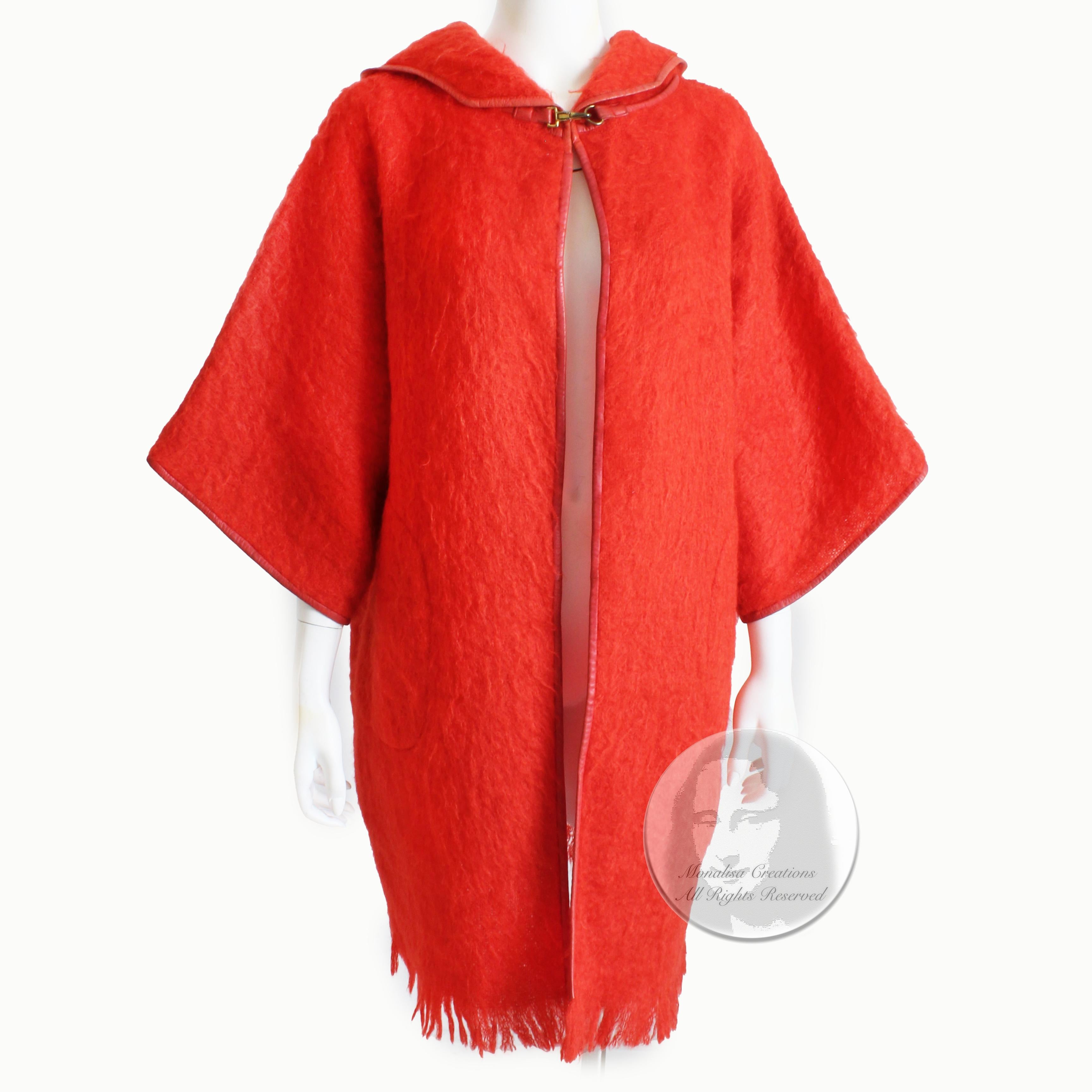 Preowned, vintage Bonnie Cashin for Sills mohair wool coat with hood, likely made in the 1960s.  Made from a brilliant coral-hued mohair wool, it features an attached hood, Kimono-style sleeves and half moon pockets at each hip.  It's trimmed in red