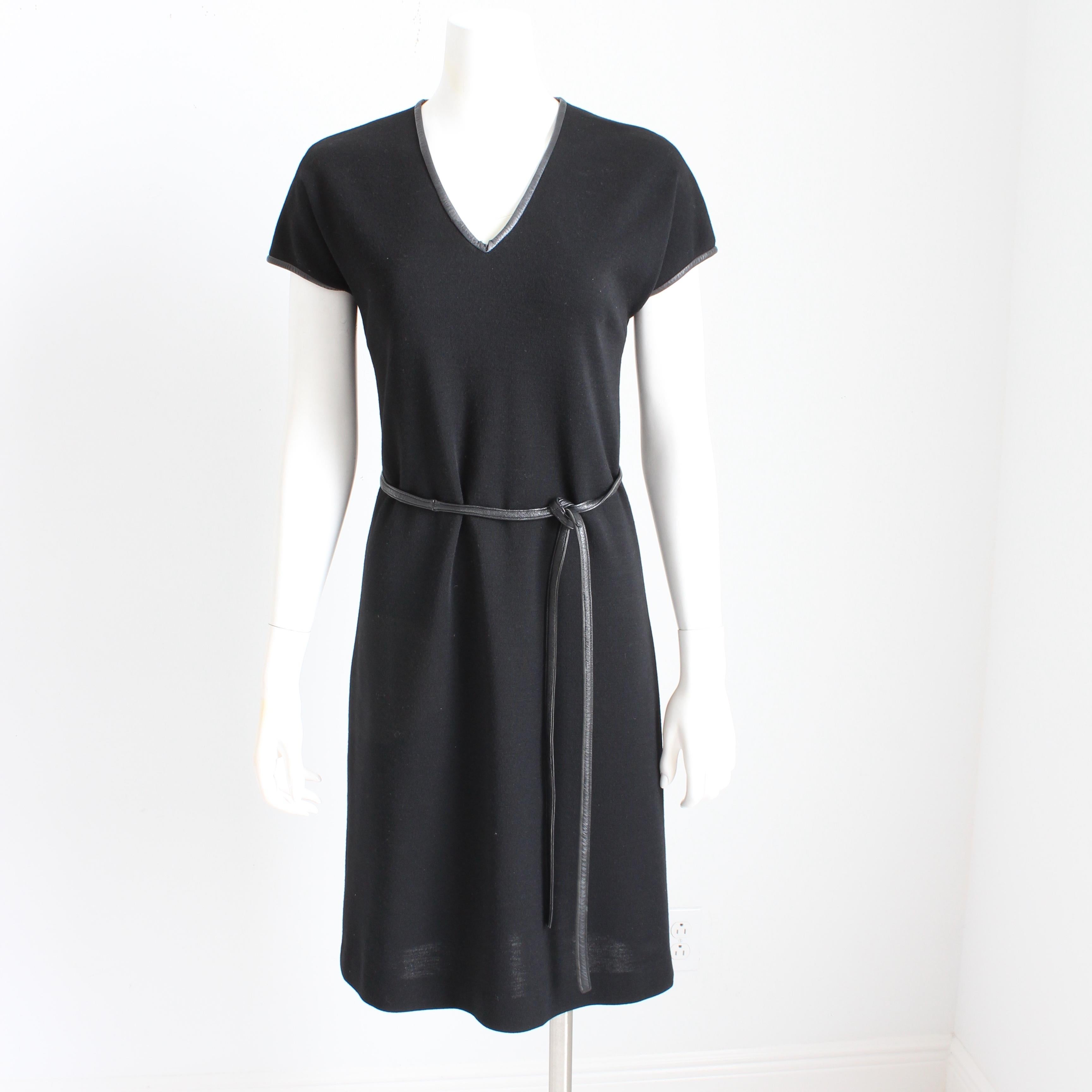 Authentic, preowned, vintage Bonnie Cashin for Sills black knit v-neck dress with matching leather string belt, circa the 60s. Ultra mod! 

Made from a black wool jersey fabric, it features a v-neck and cap sleeves, and is trimmed in black leather.
