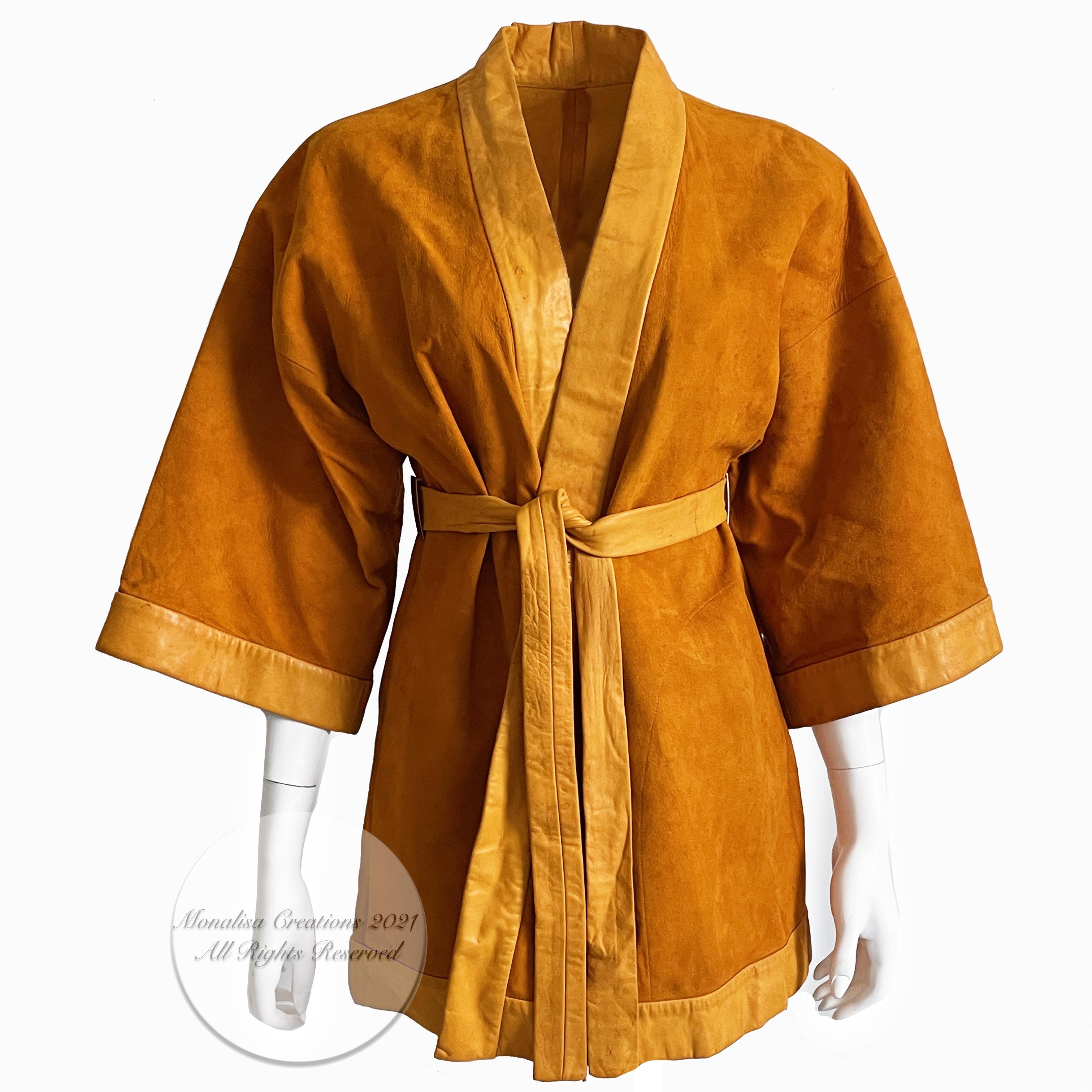 Authentic, preowned, vintage 60s Bonnie Cashin for Sills Kimono Style Jacket, likely made in the 1960s. Originally sold by Saks Fifth Ave. Made from dark orange or pumpkin-hued suede with smooth leather trim & belt, it's unlined with half-moon