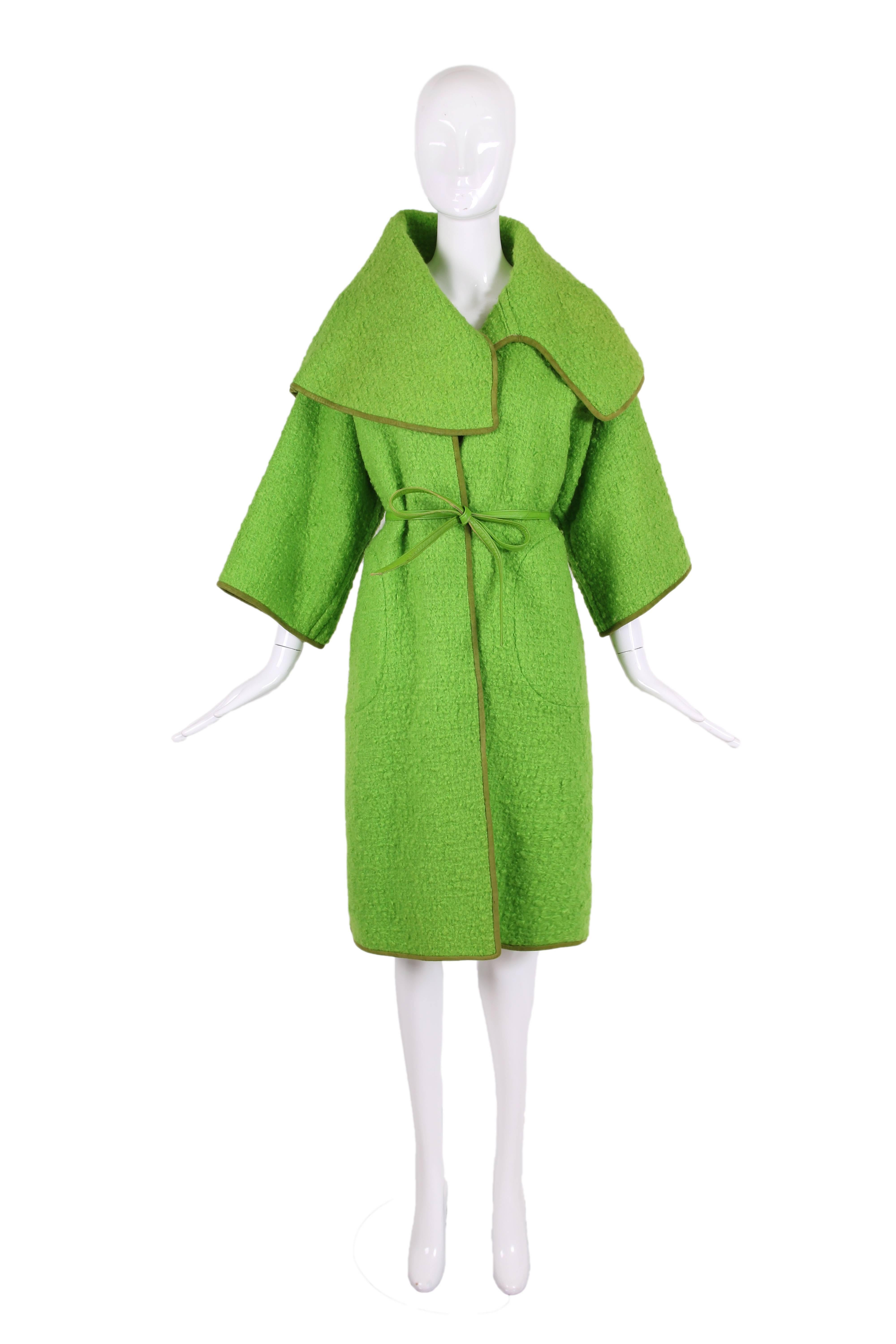 1960's Bonnie Cashin for Sills lime green boucle wool coat with olive green suede trim and chartreuse leather belt. The belt is held in place with gold-toned belt loops at each side of waist. The coat features an over-sized collar that comes to a