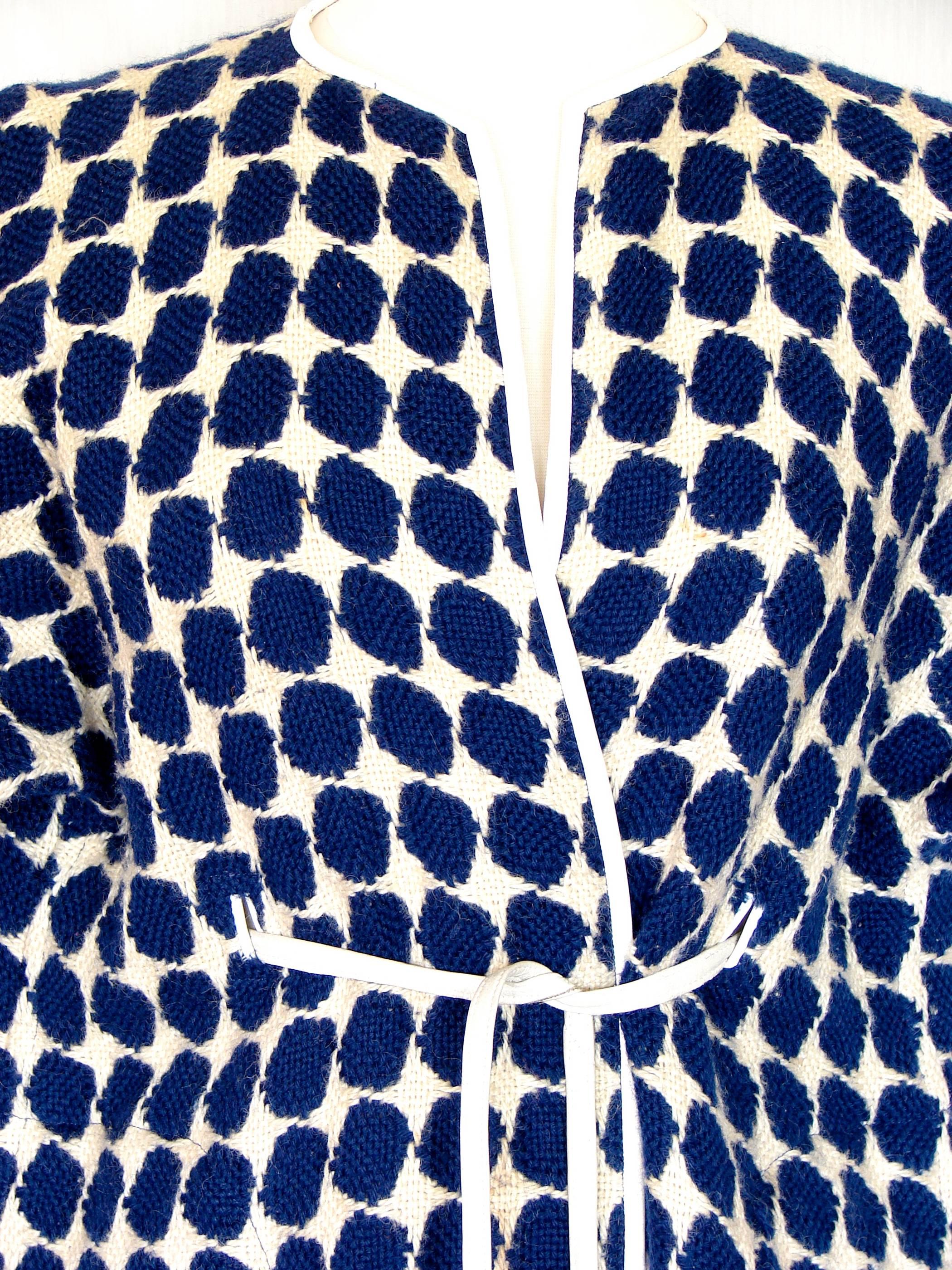 Incredibly rare Op Art wool and leather coat from the mother of American Sportswear, Bonnie Cashin.  This is her NOH style coat, inspired by her travels to Asia, and designed for layering.  Unlined and in excellent condition, we note some minor wear