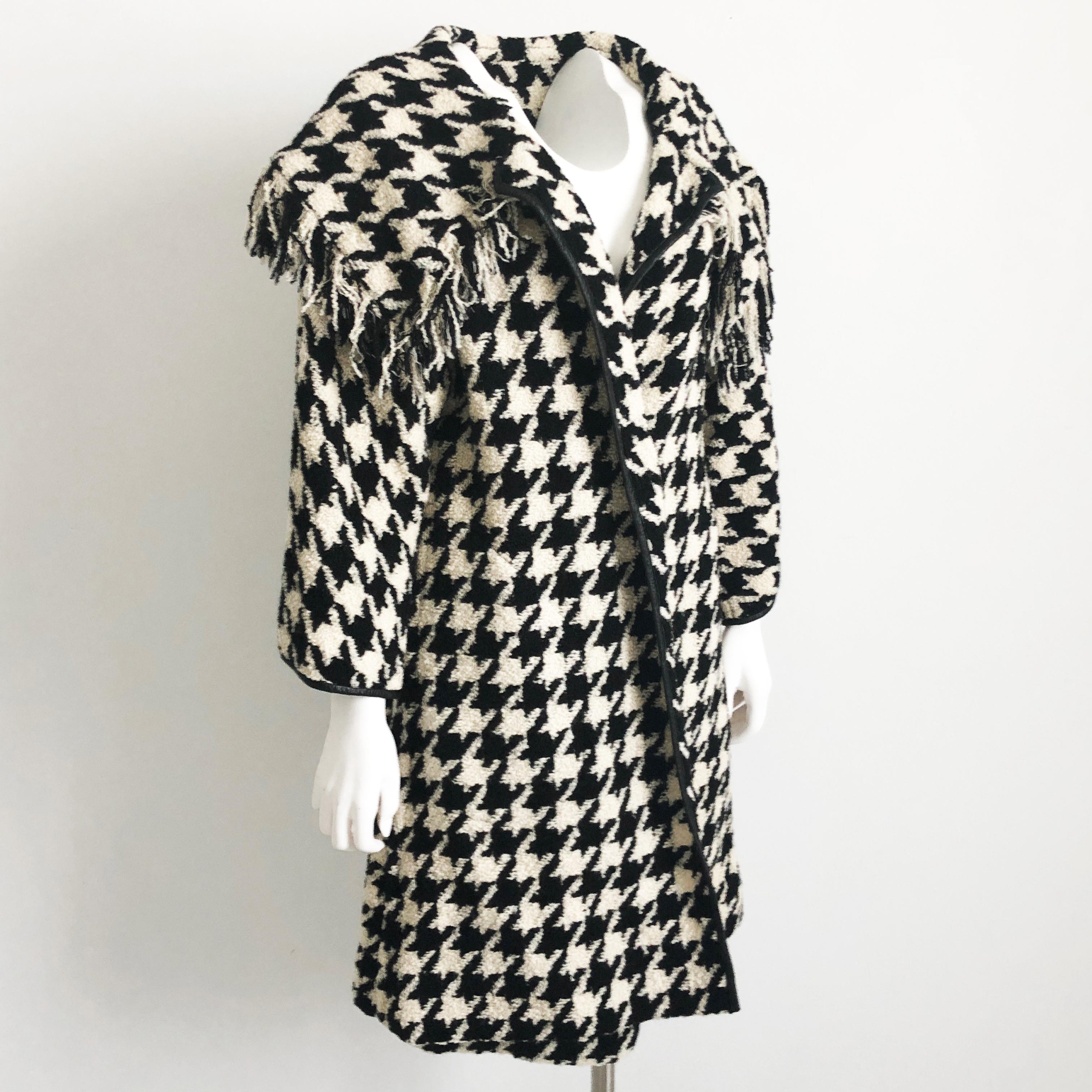 This fabulous ensemble was designed by the mother of American sportswear, Bonnie Cashin. Made from an amazing large houndstooth boucle wool knit, the jacket is trimmed in black leather & features a huge shawl collar with fringed edge.  The pencil