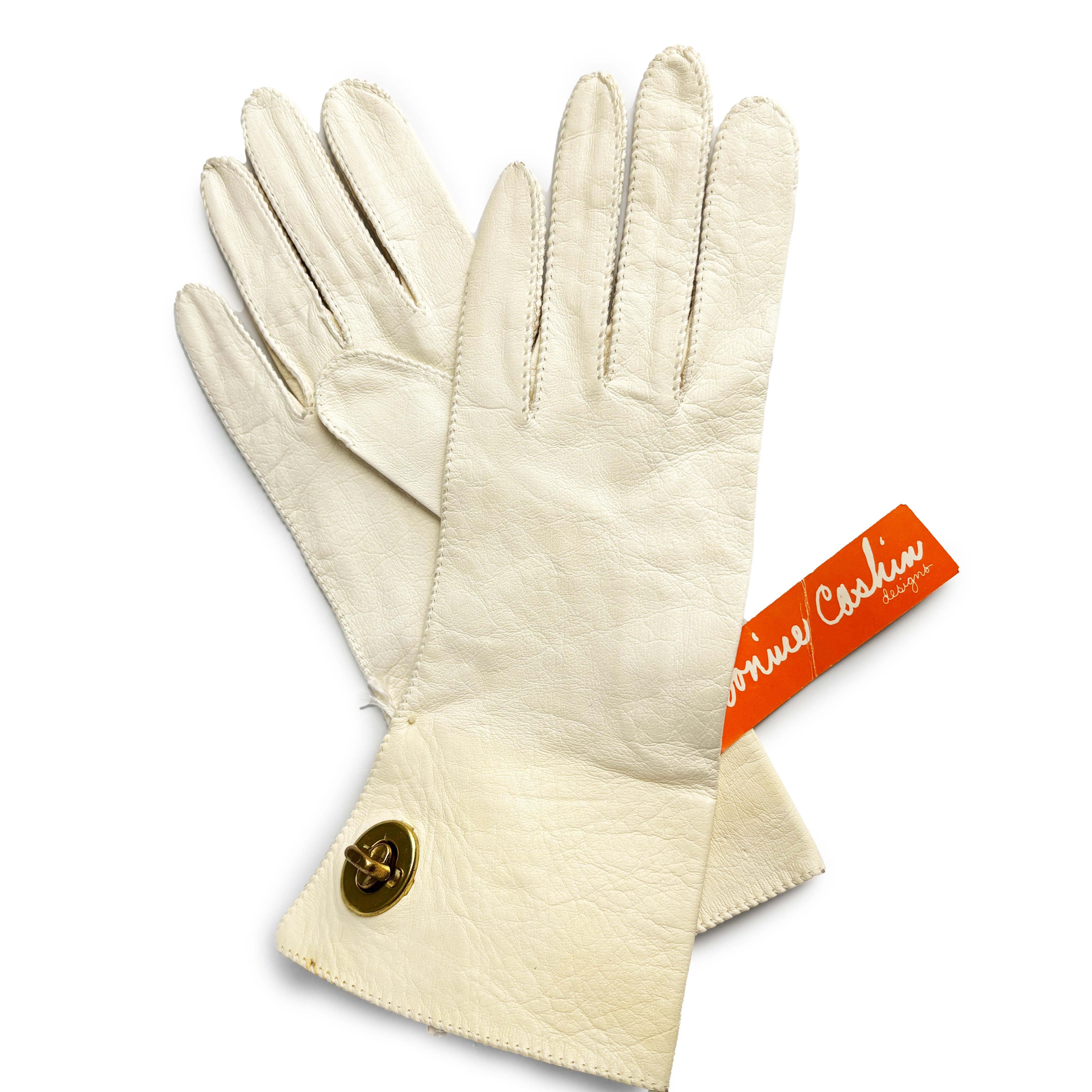 Preowned, vintage Bonnie Cashin for Crescendoe Superb leather gloves, likely made in the late 60s.  Made from butter soft creme-hued leather, these incredibly rare gloves feature Bonnie's signature brass turn lock fasteners at the wrist, which keeps