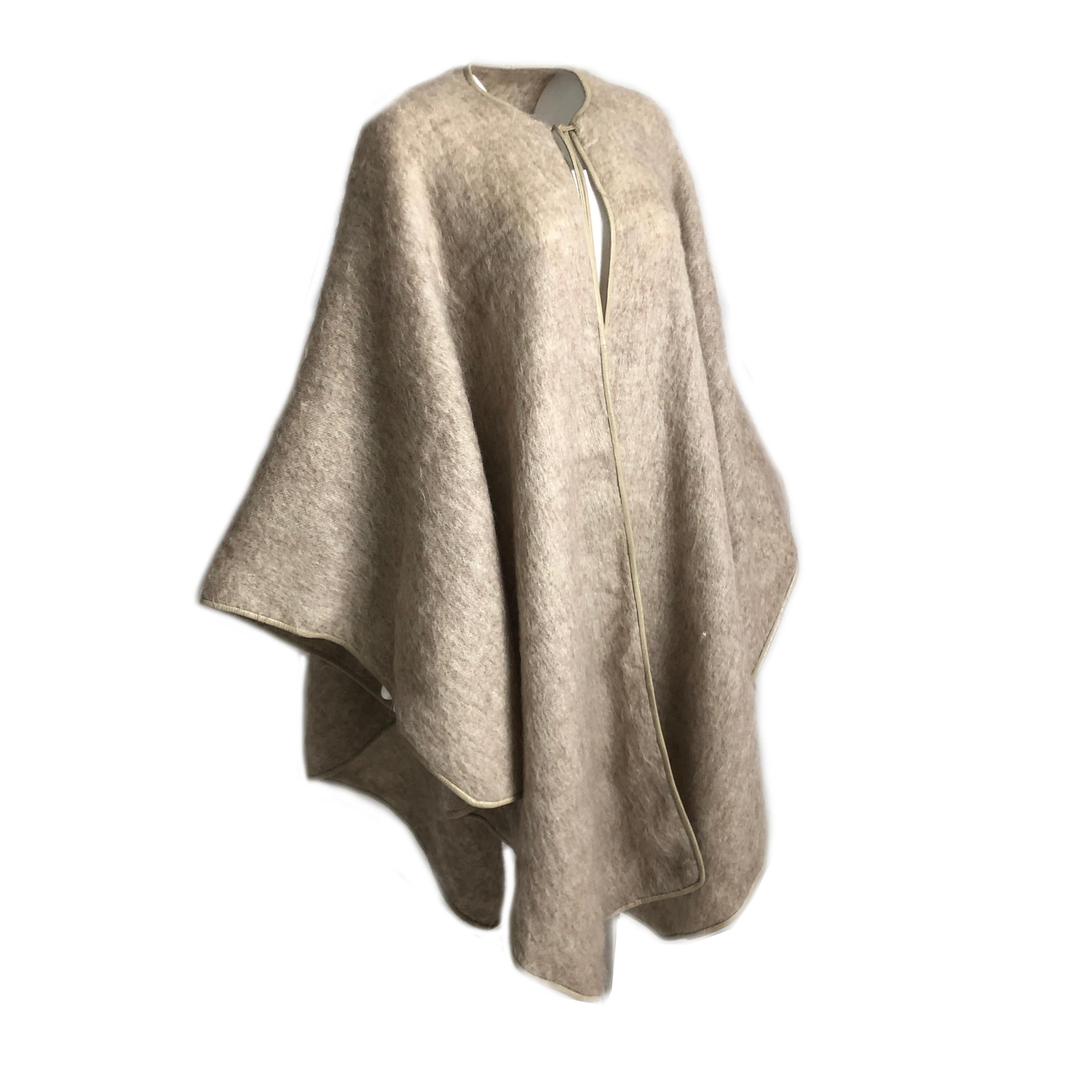 Authentic, preowned, vintage & fabulous Bonnie Cashin for Sills Mohair Cape with Leather Trim. Wheat colored mohair/cream leather trim. Unlined/fastens w/2 leather ties at collar. Perfect fall cover, & looks amazing with everything from jeans to