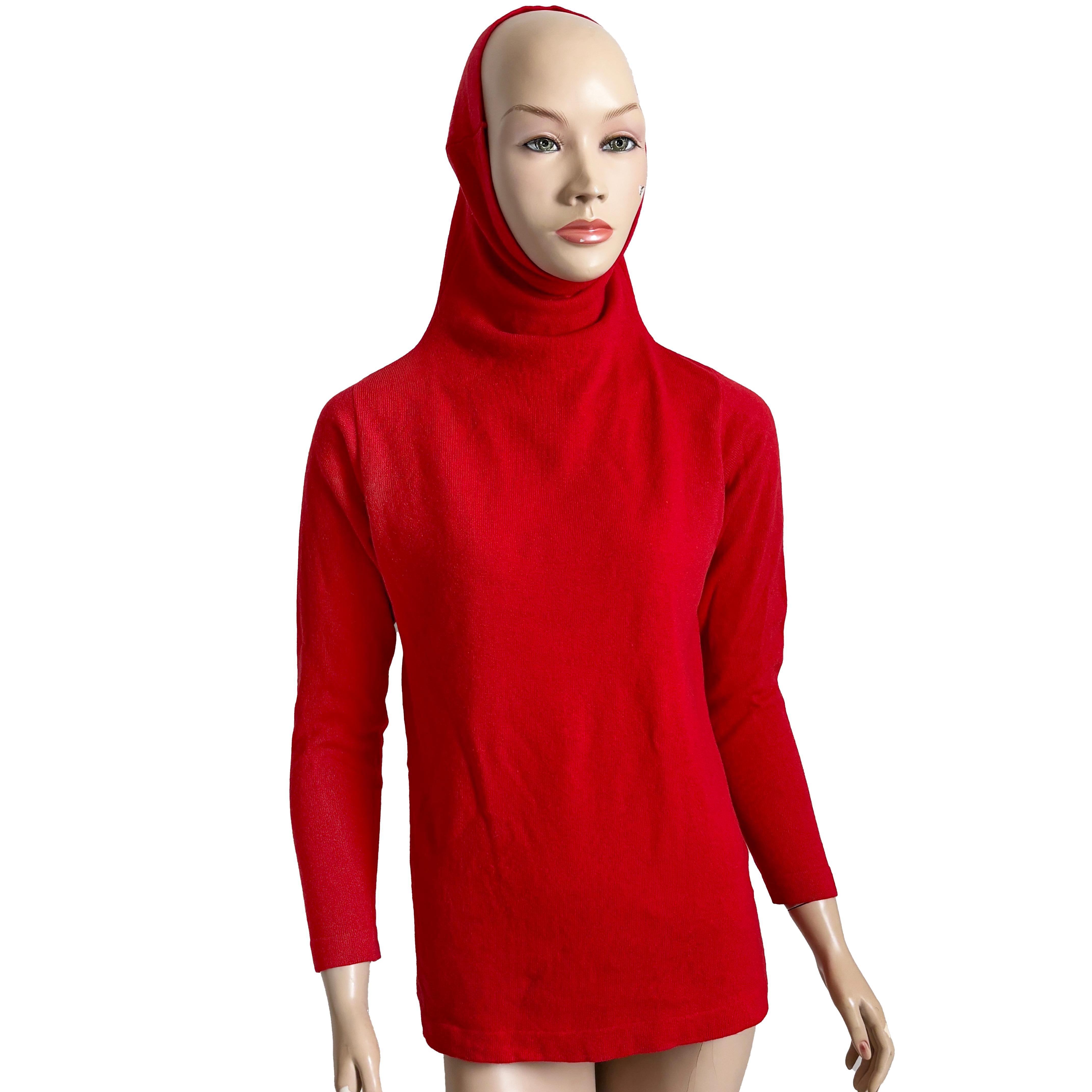 A striking and collectible piece from the legendary designer Bonnie Cashin, this vintage 1970s sweater embodies her modernist approach to American sportswear. Crafted in a bold, fiery red cashmere knit, the silhouette is streamlined yet dramatic,