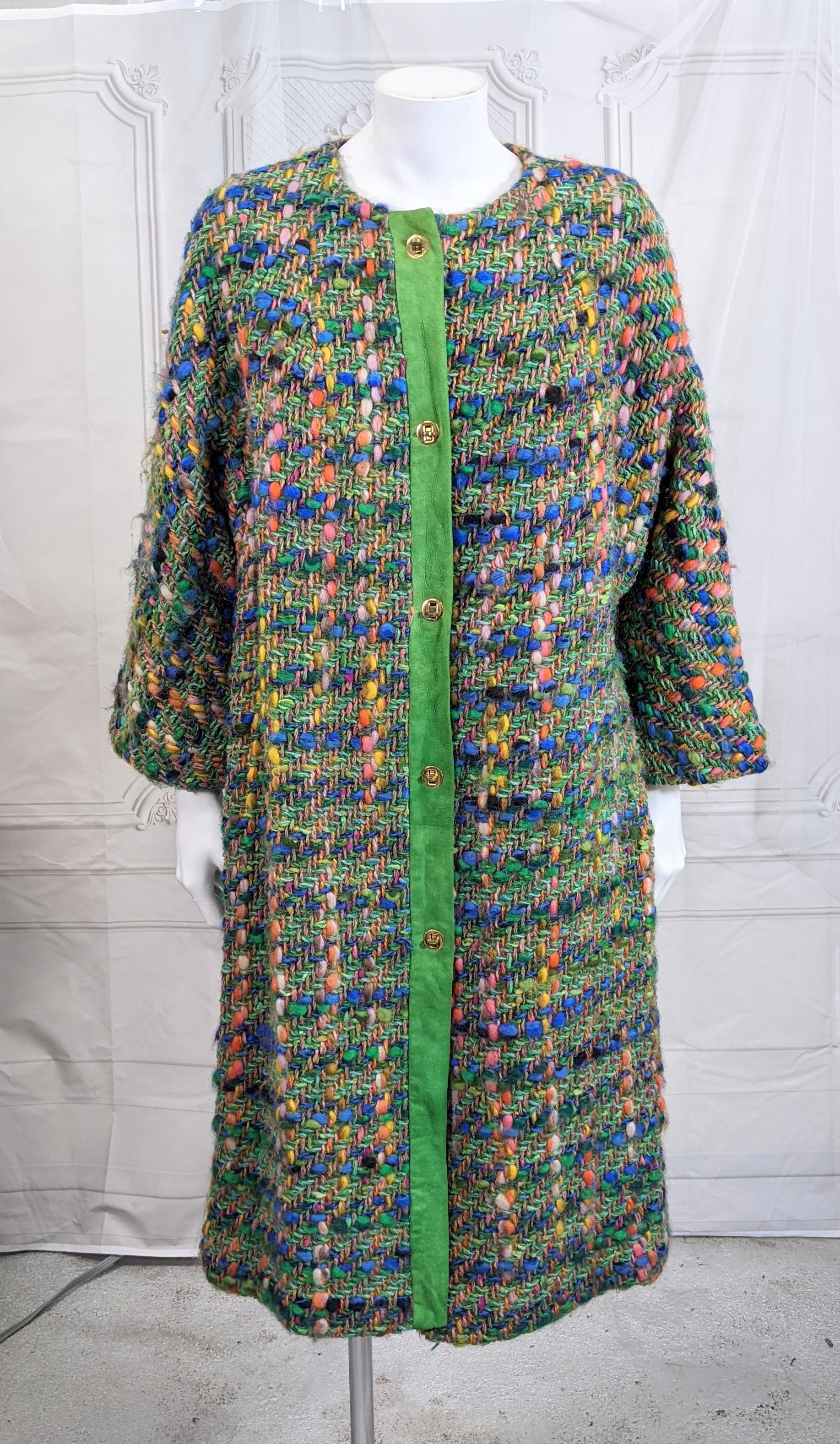 Easy Bonnie Cashin Technicolor Wool Tweed Coat with bright green suede trim and signature brass toggle trim. Easy cardigan coat straight shape with incredibly colorful nubby tweed.
Side pockets, deep dolman sleeves.
Marked: Size B, Medium.  Cashin