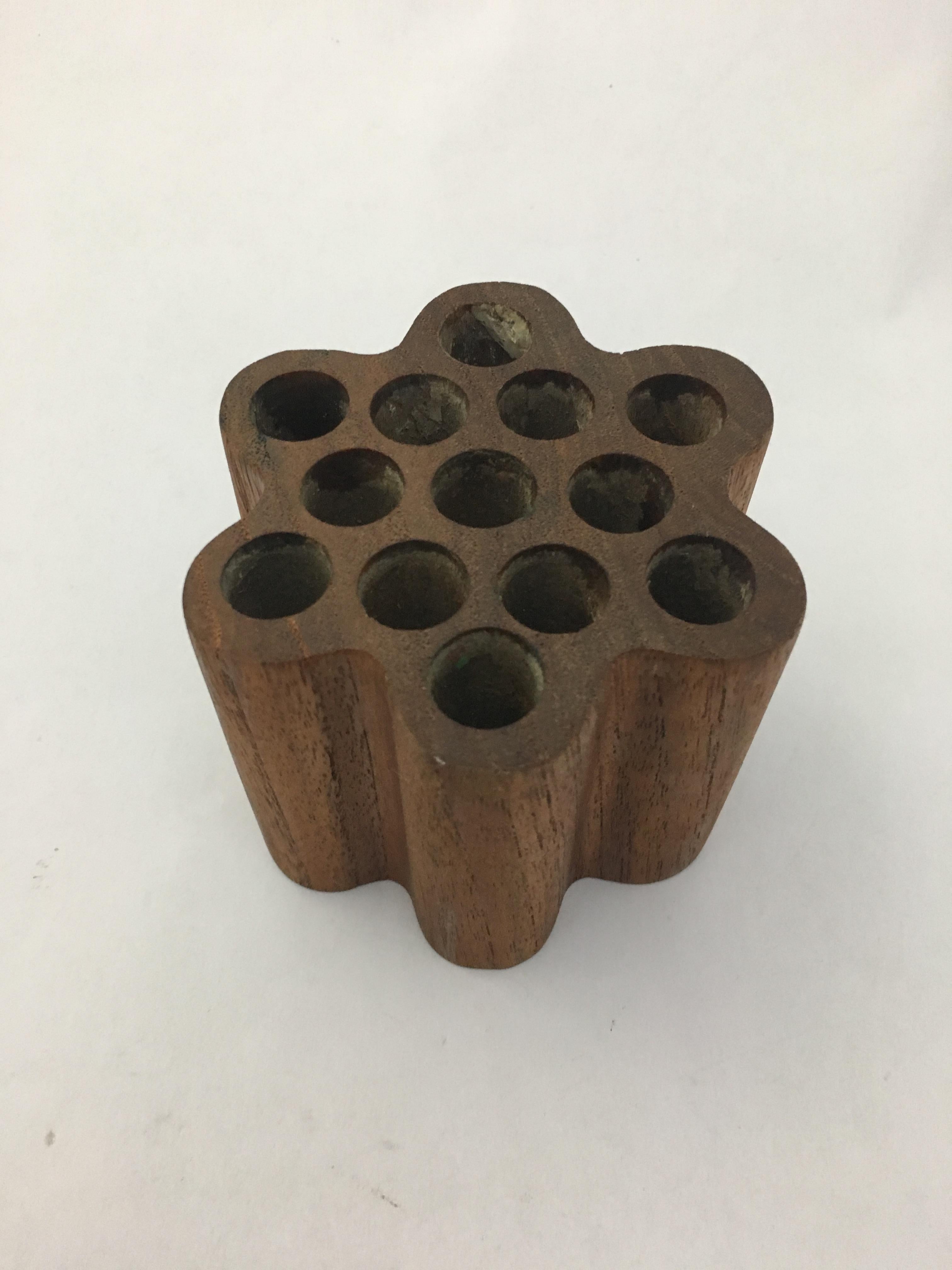Retailed at Bonniers, New York City, circa 1960. Swedish teak pen or pencil holder that can hold up to 13 writing implements. Signed on bottom, Made in Sweden for Bonniers.