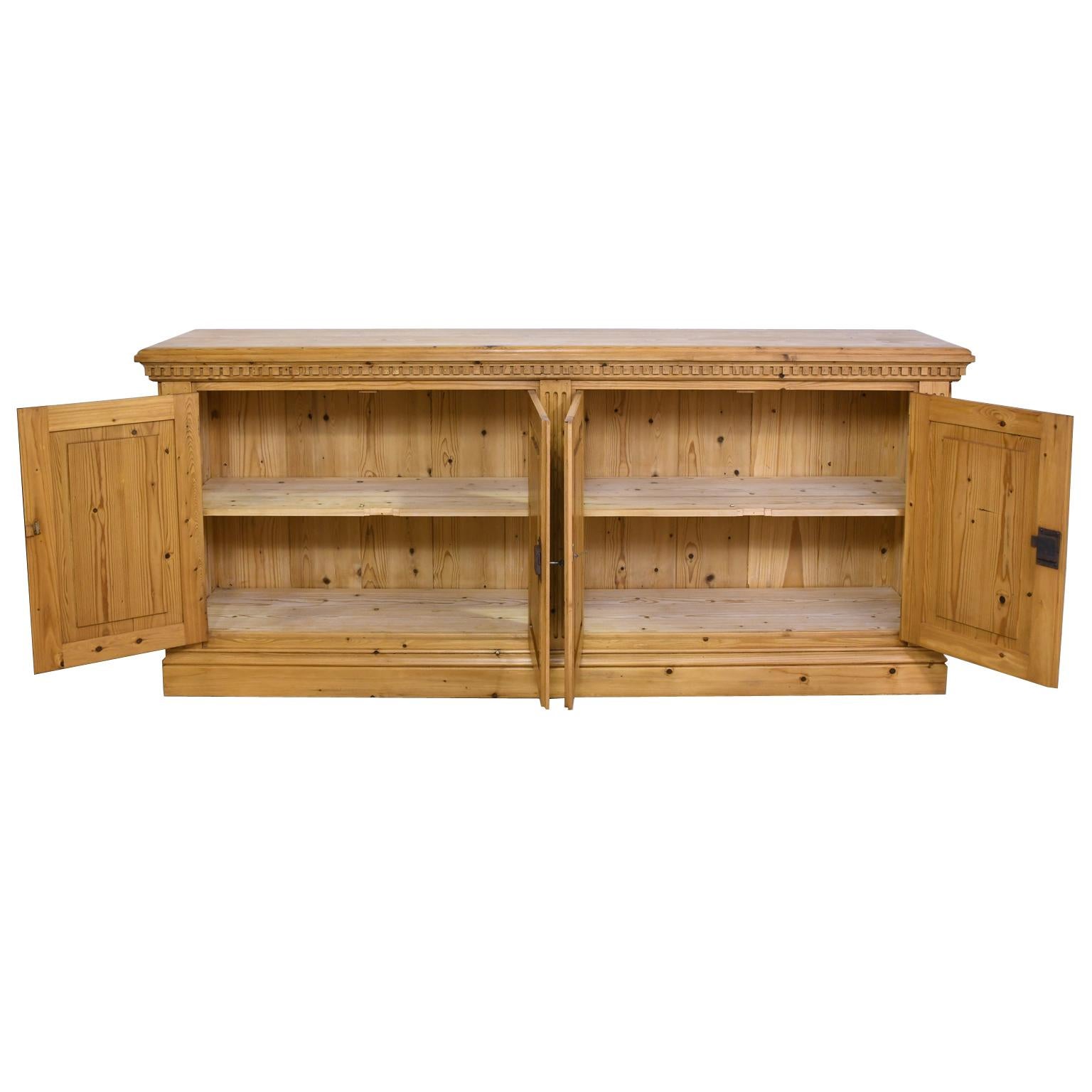 A sideboard or credenza made to order in our workshop and available in custom sizes, different woods and custom finishes. As shown, the sideboard is in repurposed antique pine in a light, honey-colored tone with a wax finish. Features a dental