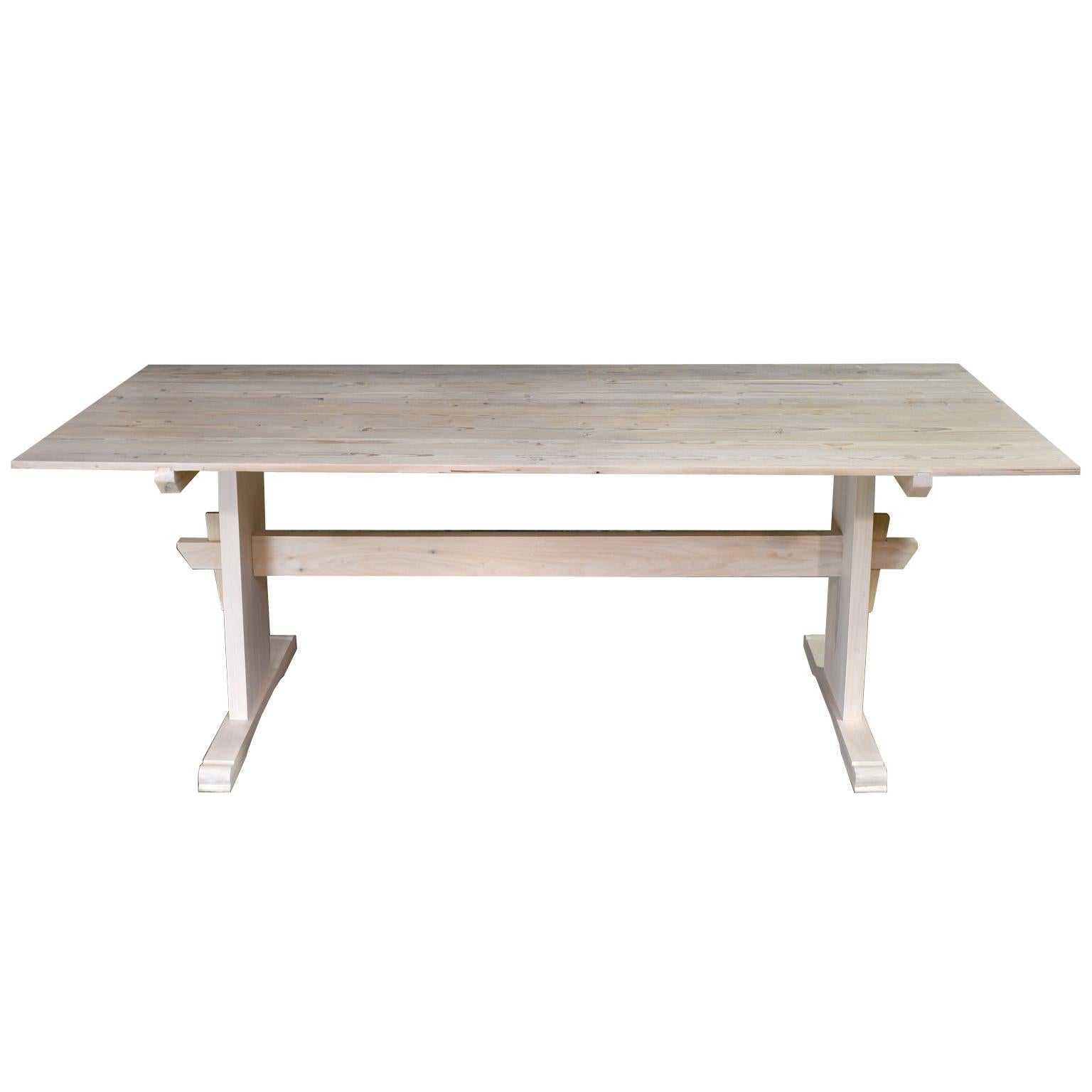 A Bonnin Ashley custom made, dining table with plank-top and trestle base made from repurposed European pine. We can manufacture this Scandinavian-inspired table in any size up to 10' long. We offer a variety of trestle bases that will work with