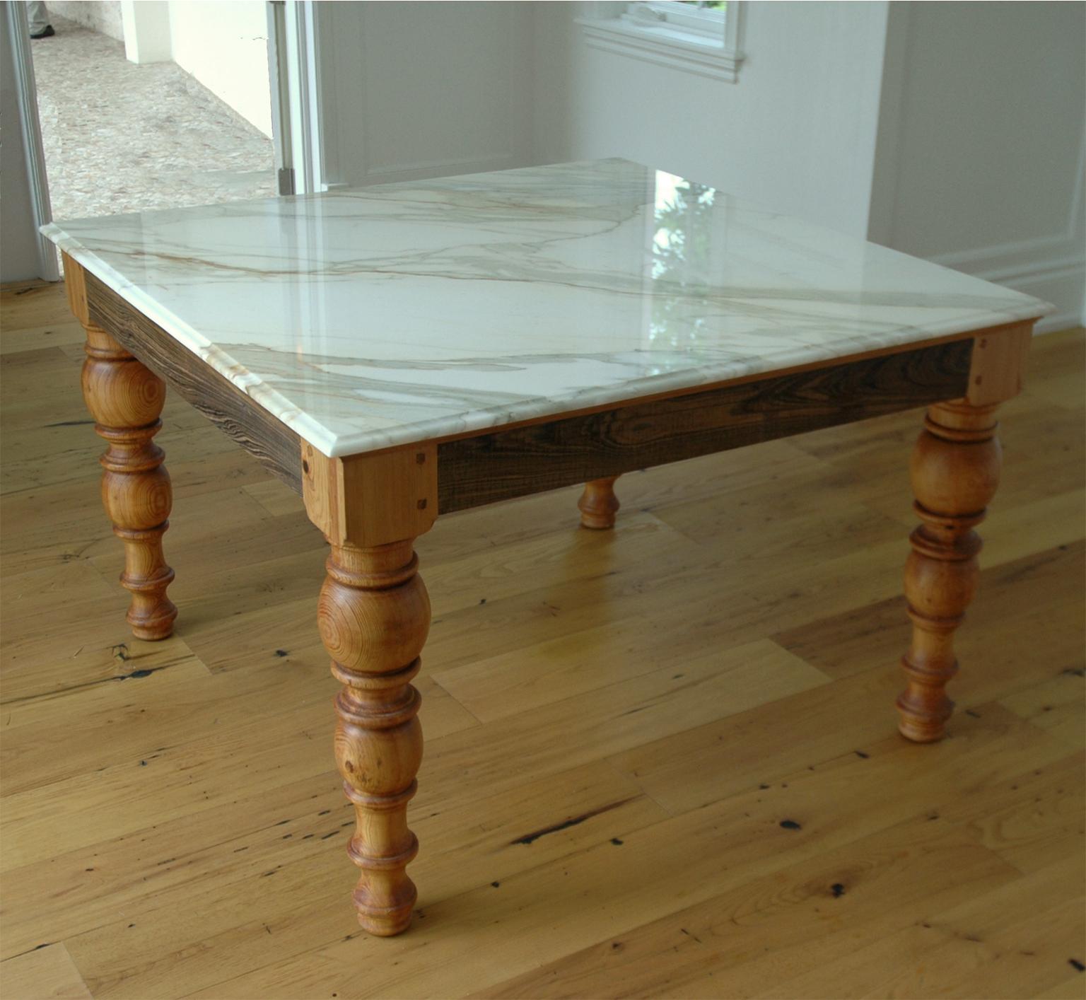 A beautiful & very-well crafted pine dining table, custom-made in our workshop with massive, Scandinavian-style legs turned from reclaimed pine beams that support a beautiful Calacatta gold or white Carrara marble top with an O-gee edge. (Shown with