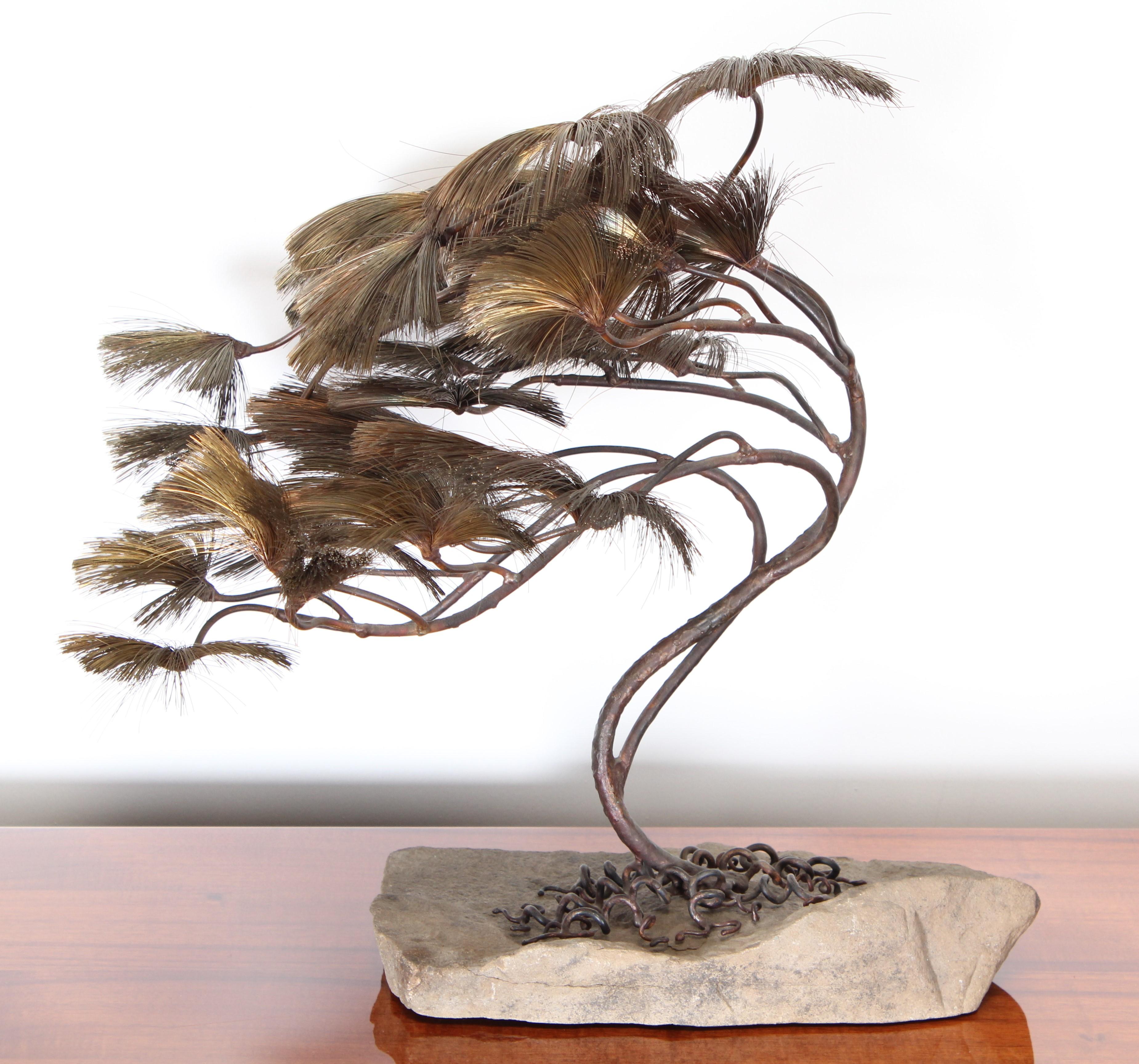A unique Brutalist modern mixed metal tree sculpture by John Steck. A Bonsai form tree with copper wire fronds. Curly metal roots on natural stone base. Unsigned.

Tree dimensions: 20.5