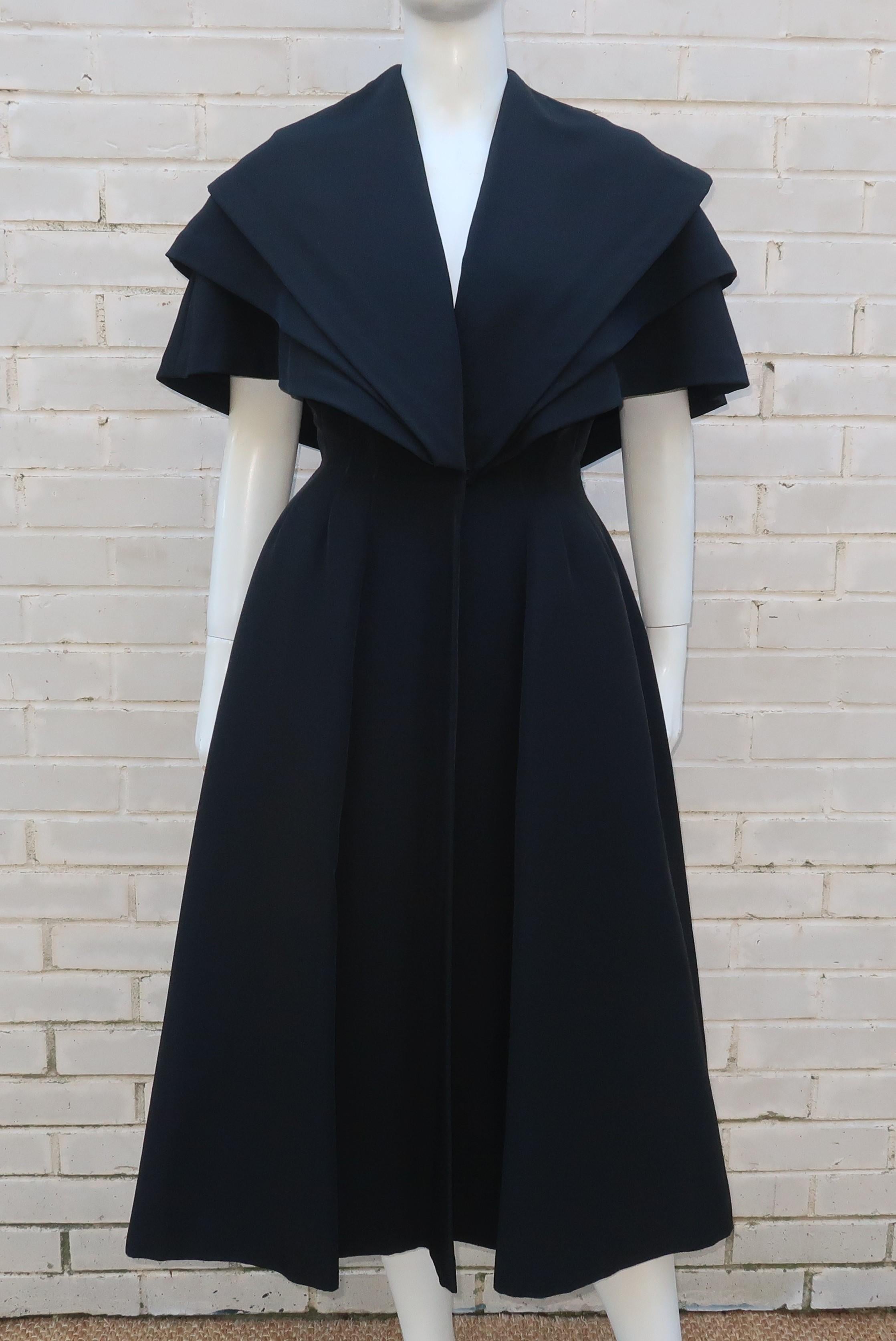 This amazing piece sold through Bonwit Teller, Philadelphia, C.1950, and is intended to be an evening coat but it could easily turn heads as a dress all on its own.  The heavy weight black silk faille fabric is tiered at the bodice providing a