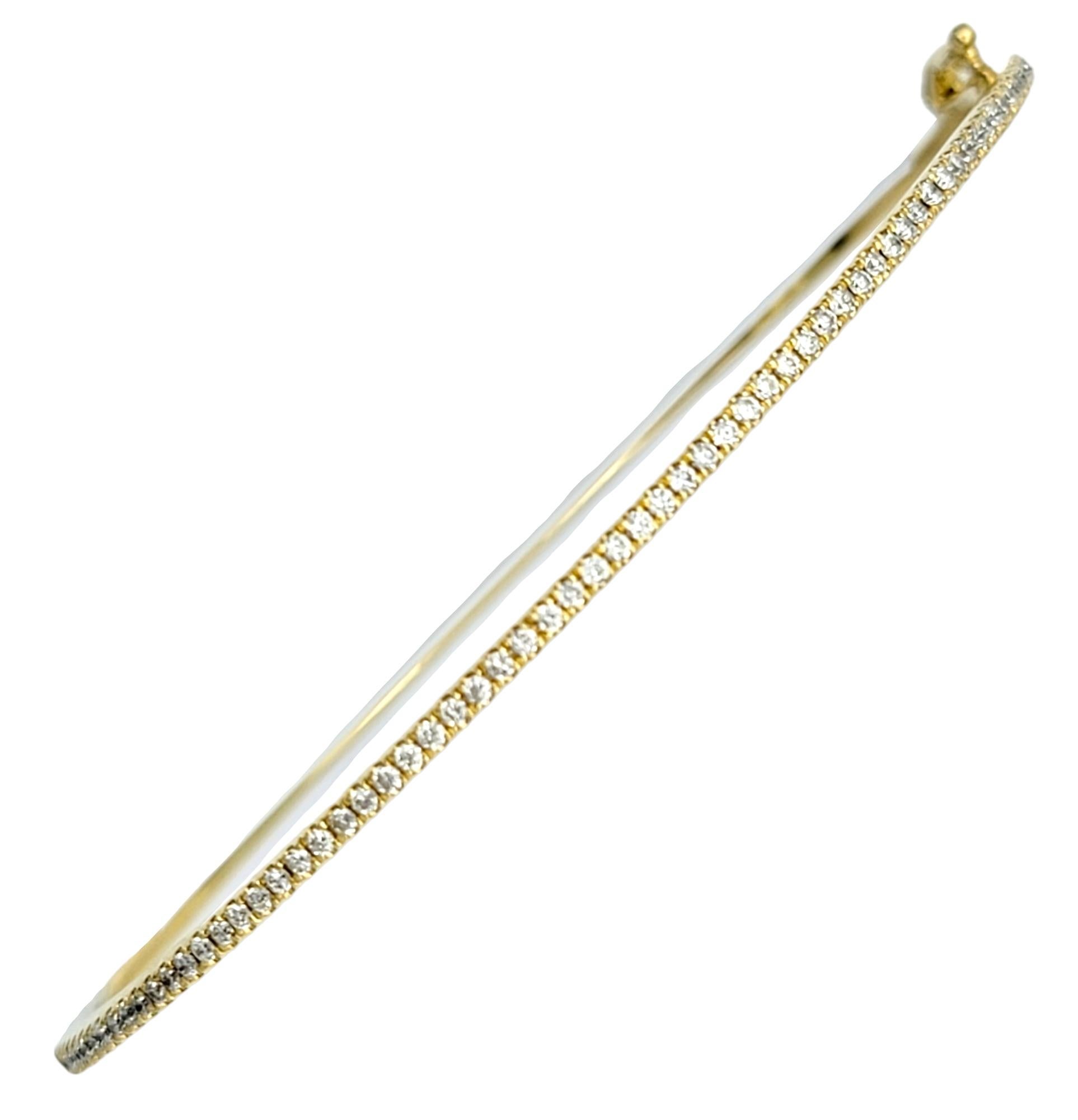 This sleek and striking 18 karat yellow gold bangle, created by Bony Levy, is a beautiful fusion of classic elegance and modern luxury. This delicate bangle displays a captivating contrast between the rich, warm hue of the 18 karat yellow gold and