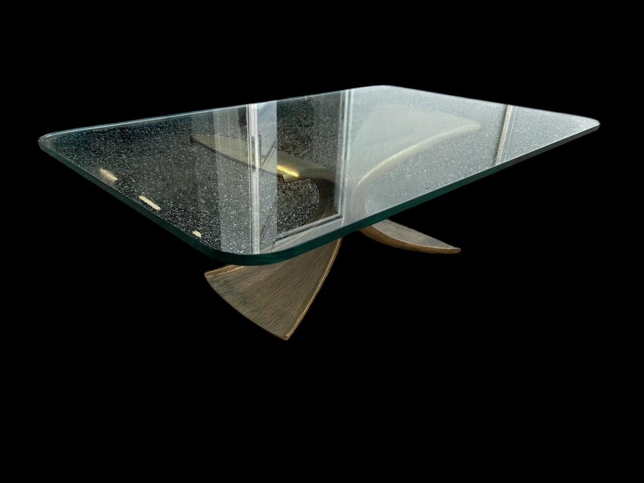 Grande table basse brutaliste avec une base organique en bronze et un plateau en verre épais , conçue dans les années 1960/70.
