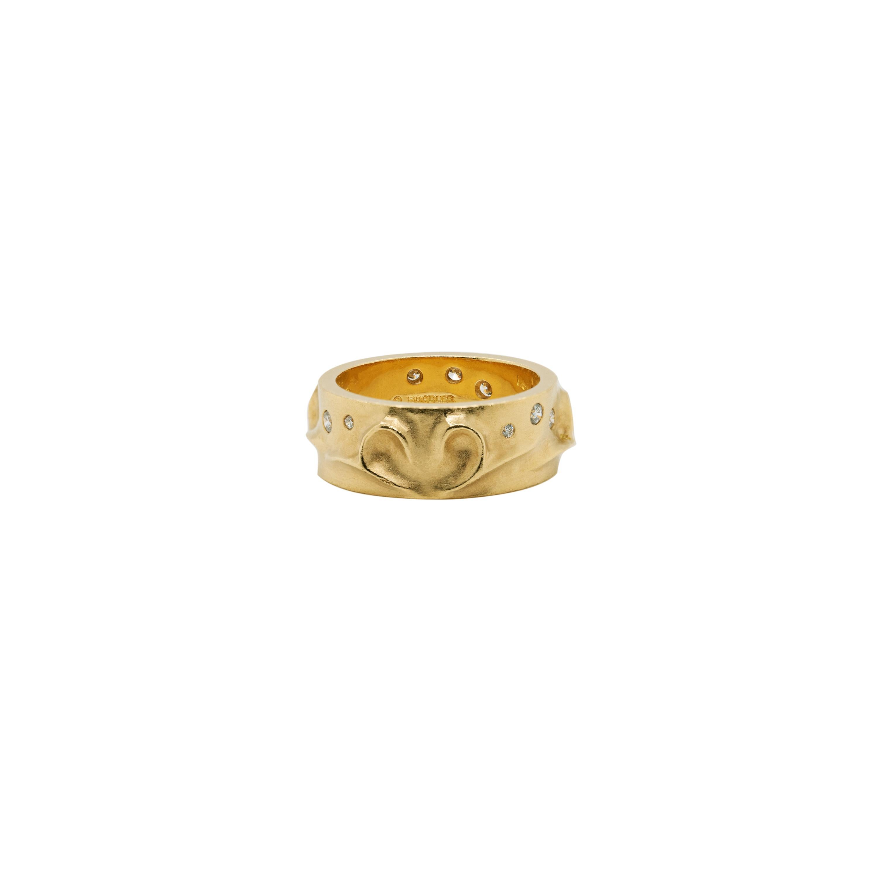 This wonderful ring and earring set designed by Boodle and Dunthorne has been crafted in 18 carat yellow gold. The earrings and ring are decorated with a raised pattern throughout in a beautiful matte finish. The earrings are inlaid with 6 round