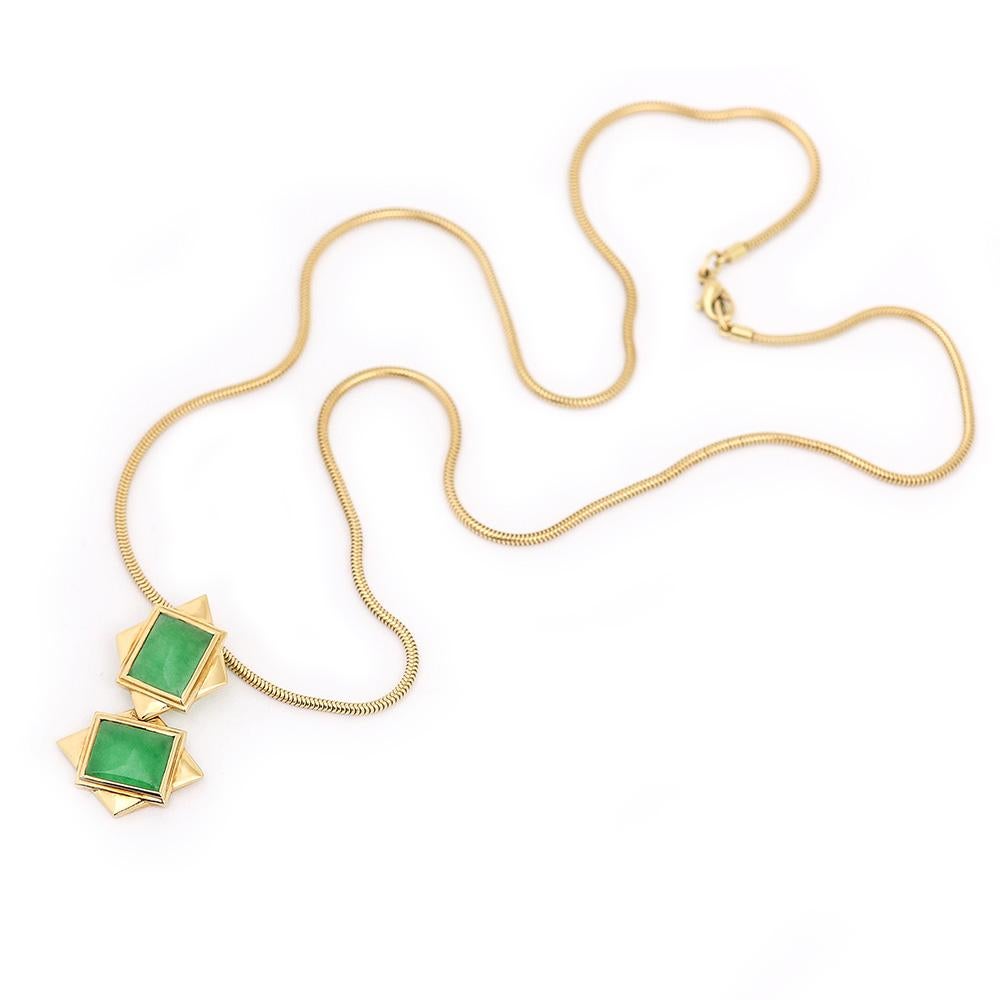 A striking Boodles & Dunthorne or Boodles 18 karat gold and jade set comprising a pendant and chain with matching ring and earrings. This Boodles 18 karat set is designed as a simple rectangular jade motif surrounded by a stepped frame in gold. The