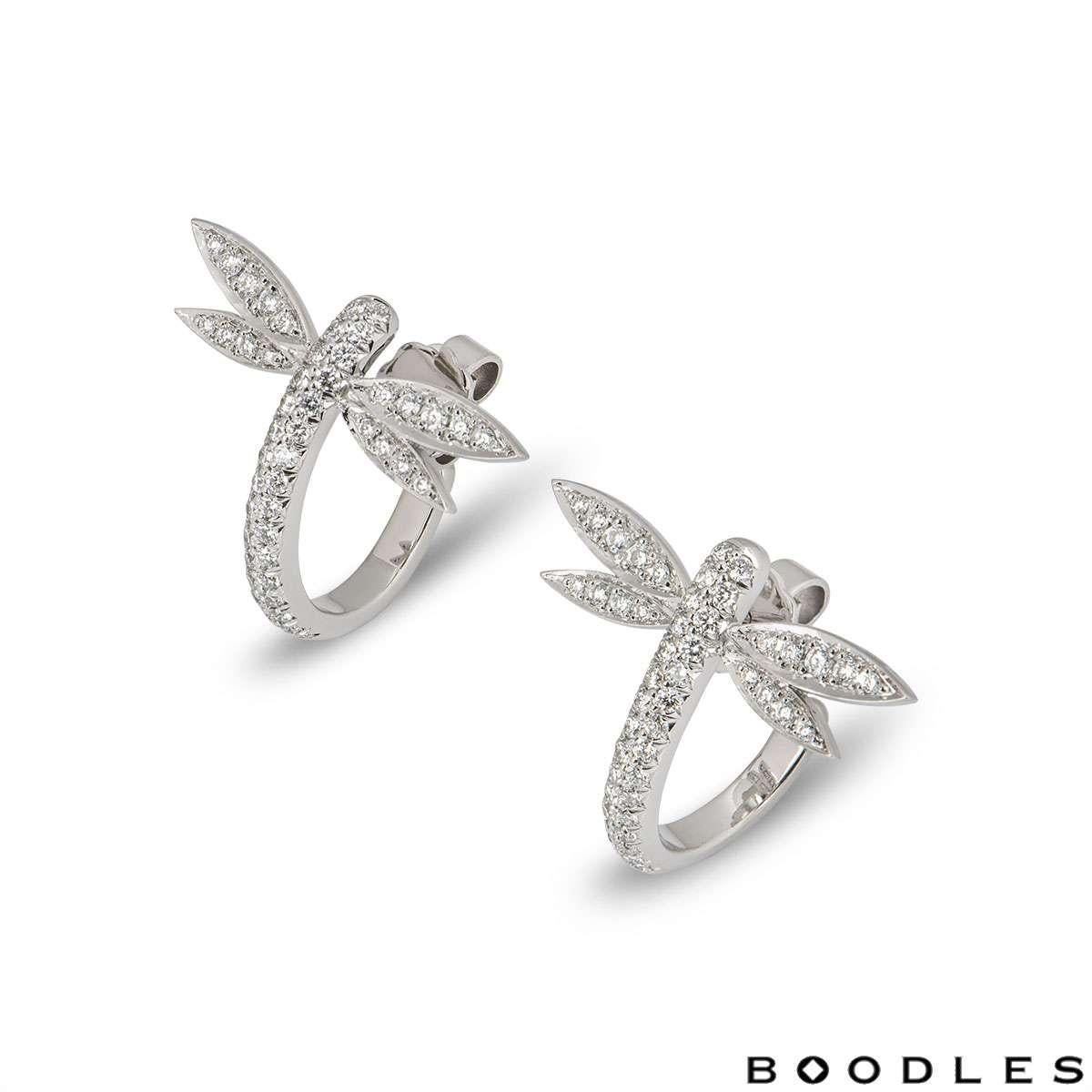 A pair of 18k white gold diamond Dragonfly earrings. The earrings are of hoop design and are set with round brilliant cut diamonds to the front. There are a total of 96 diamonds totalling approximately 0.64ct. The earrings measure 1.9cm in length