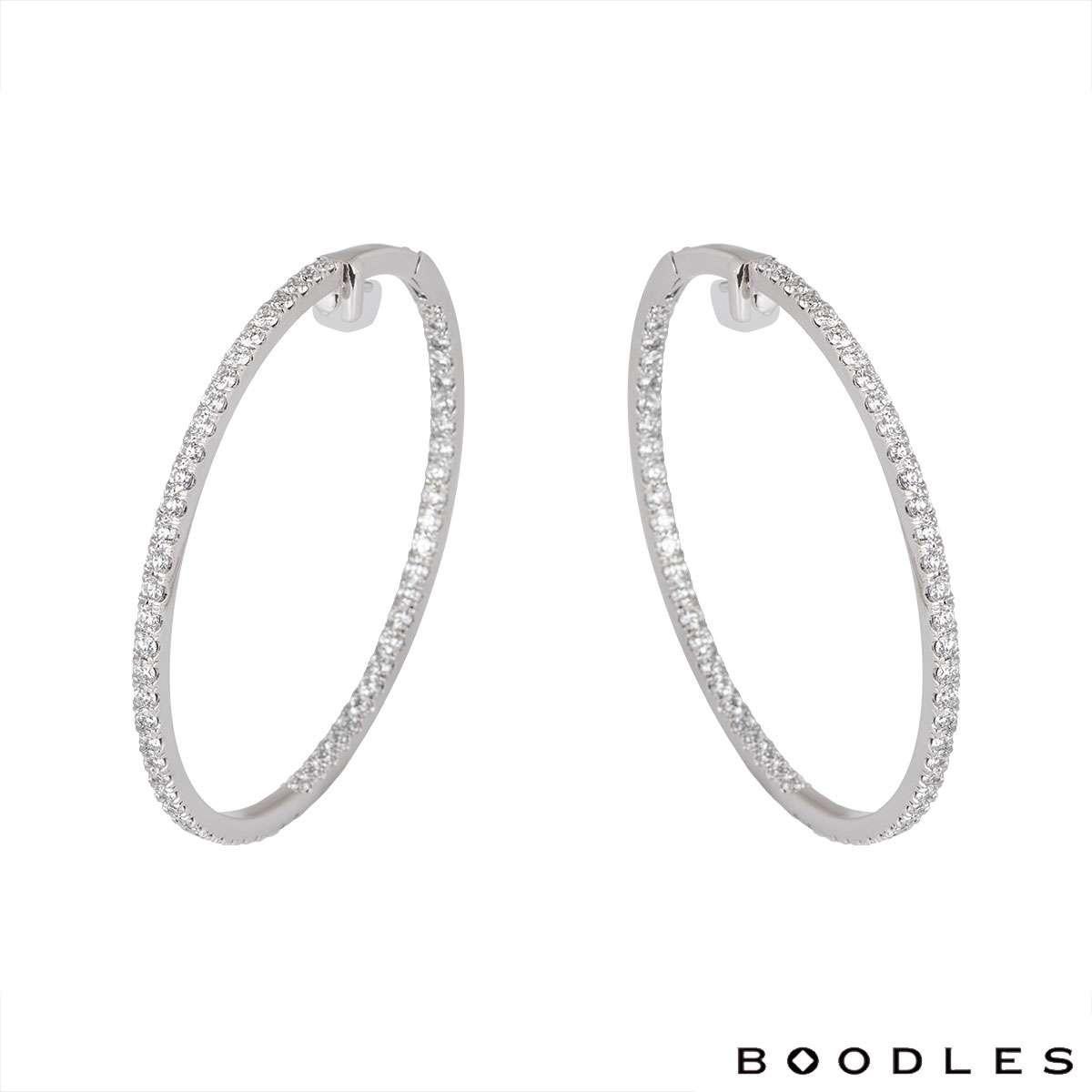 A large 18k white gold pair of diamond hoop earrings by Boodles. The earrings consist of 120 round brilliant cut diamonds set on the outer and inner line of the hoops with a total weight of 4.41ct. The earrings feature post and lever hinged fittings