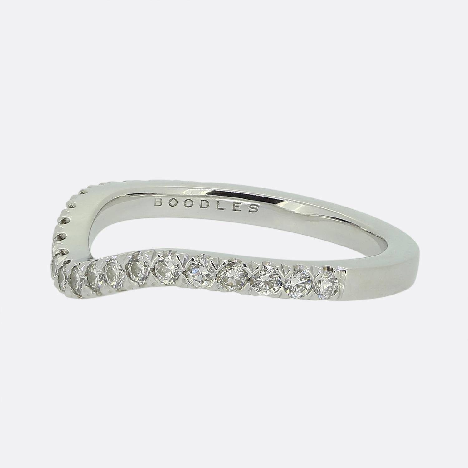 Here we have diamond wishbone wedding ring from the renowned British jewellery designer, Boodles. Crafted from platinum, the band features a graceful V-shape design adorned at the face with a single row of bright white round brilliant-cut diamonds.