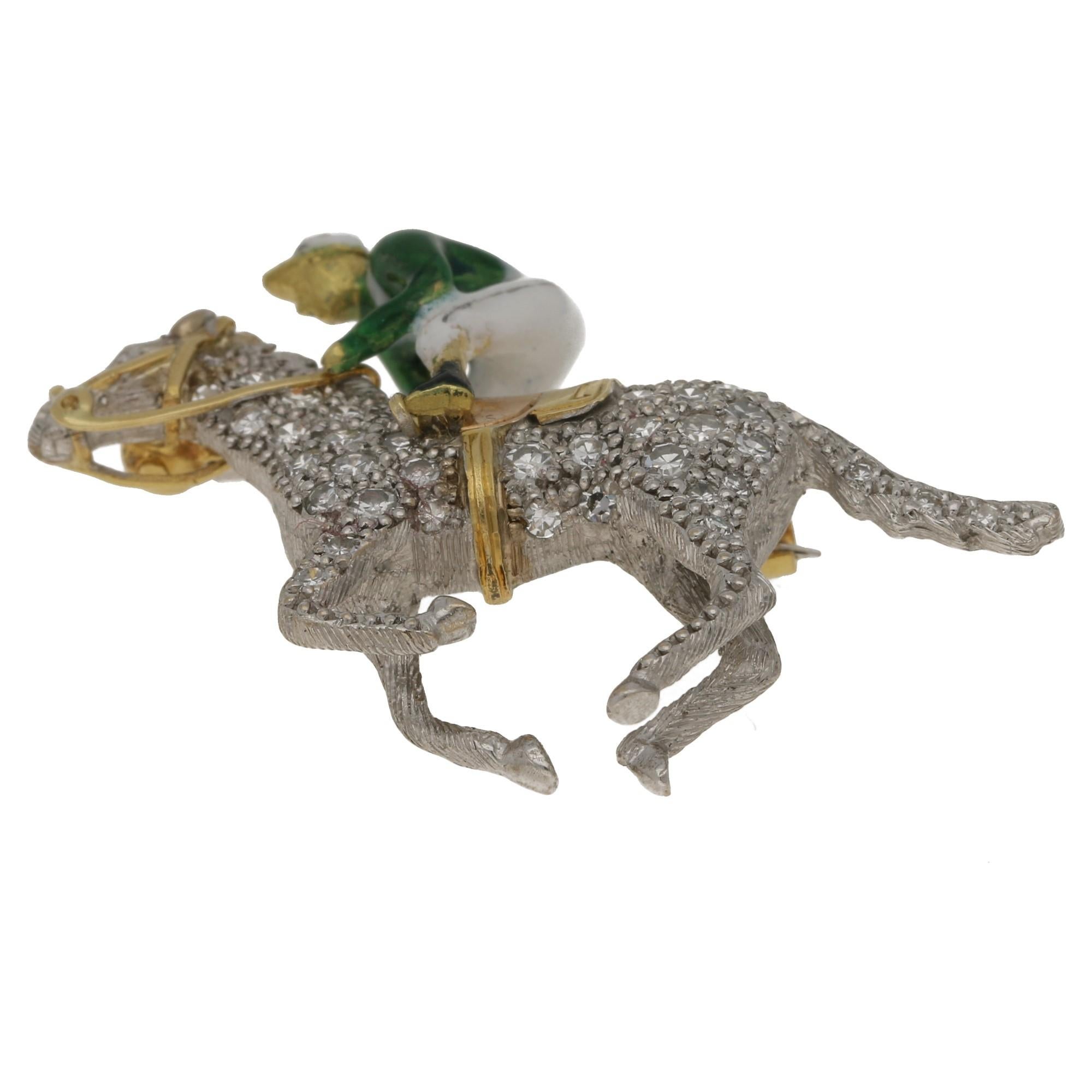 A Boodles enamel and diamond jockey brooch from 1969. Modelled as a polychrome enamel jockey riding a racehorse, pave-set throughout with 0.45 carats of single-cut diamonds, mounted in 18kt white and yellow gold, signed Boodles, maker's mark A&W for