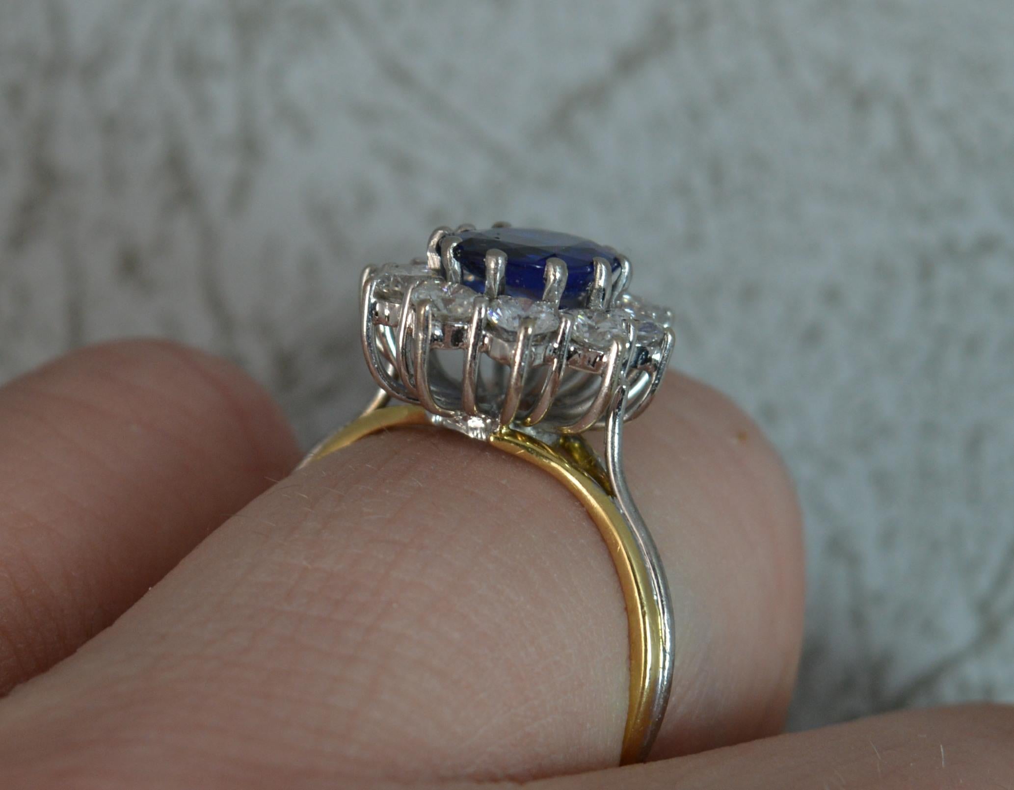 A stunning Boodles cluster ring.
SIZE ; N 1/2 UK, 7 US
​Solid 18 carat yellow gold shank with a white gold head and claw setting.
​Set with a natural oval shaped natural blue sapphire to centre with round brilliant cut diamond surrounding. The oval