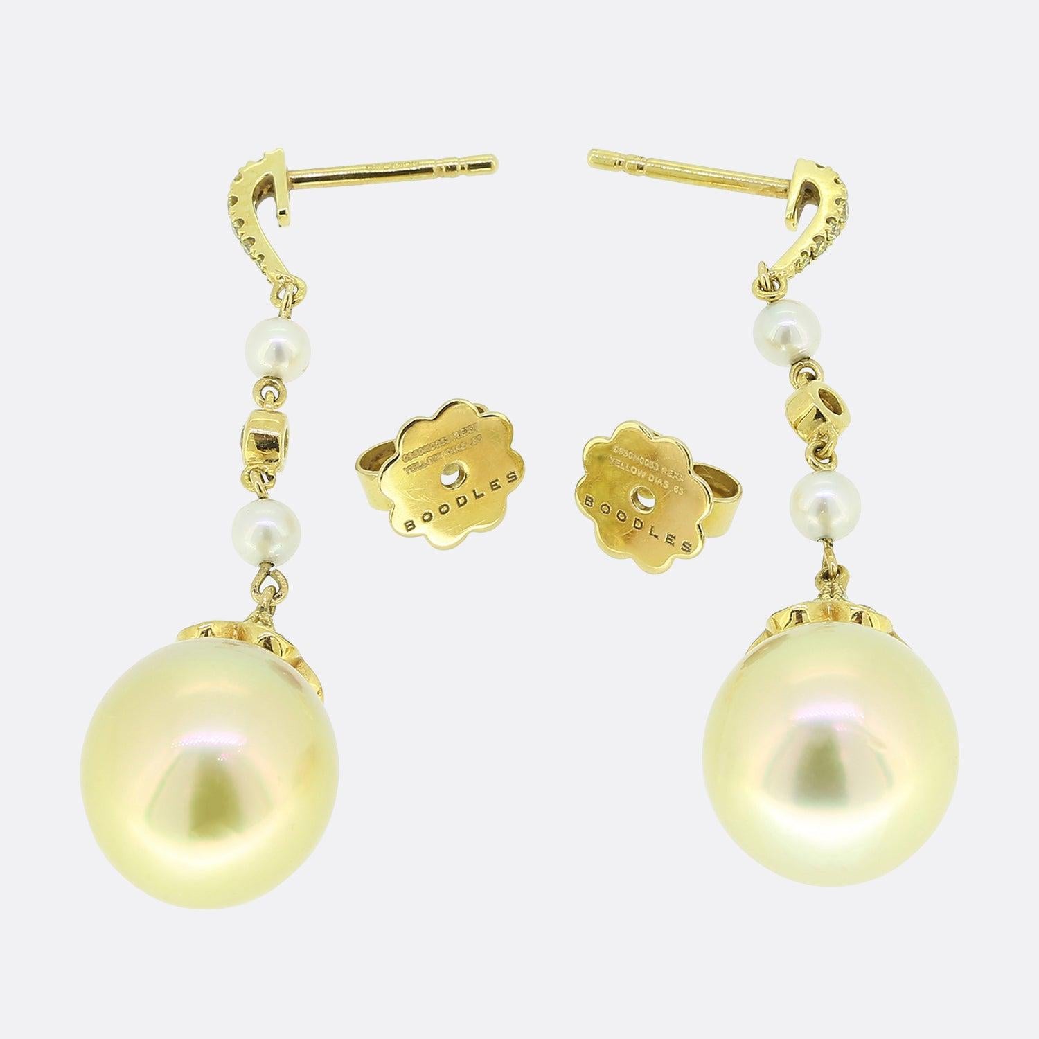 Here we have a wonderful pair of drop earrings from the luxury jewellery designer Boodles. Each earring features a single golden cultured pearl, fancy yellow diamonds and 2 white pearls. The golden pearls sit in a bell style fitting and are