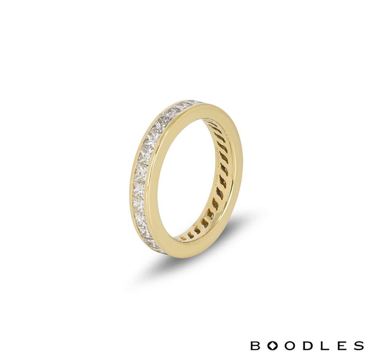An 18k yellow gold full eternity ring by Boodles. The ring is set with 28 princess cut diamonds with a total diamond weight of approximately 2.24ct. The ring measures 3.4mm in width and is a size UK K - EU 50 - US 5.25, with a gross weight of 3.8