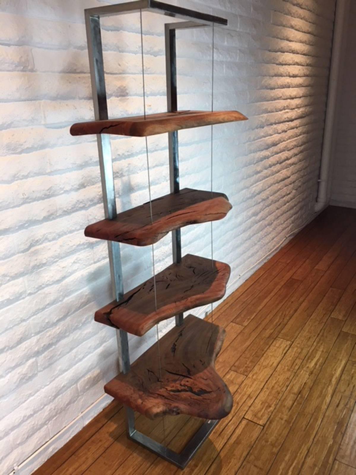 Pleasant presentation of a steel and eucalyptus wood book case or display stand designed, produced and made by master wood artist and designer Scott Mills who only uses reclaimed (deadfall or storm downed trees) in the pieces he designs and