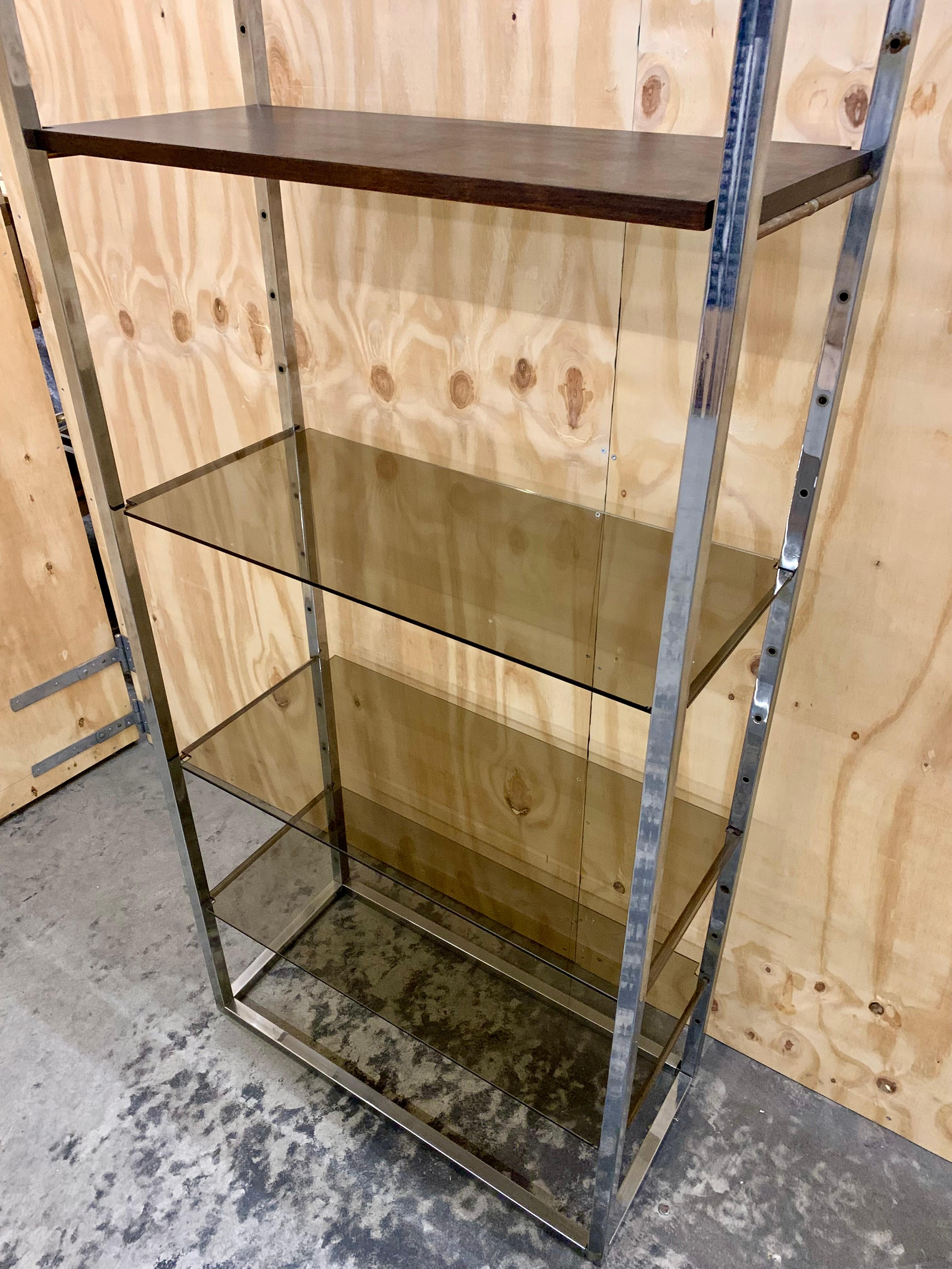 Cool vintage tall chrome book case from 1960-1970s. There are 4 smoke colored glass shelves and 1 wooden shelf, all movable, in each book case. At the moment we have 4 pieces on stock at our remote warehouse.

Price is pr. book case