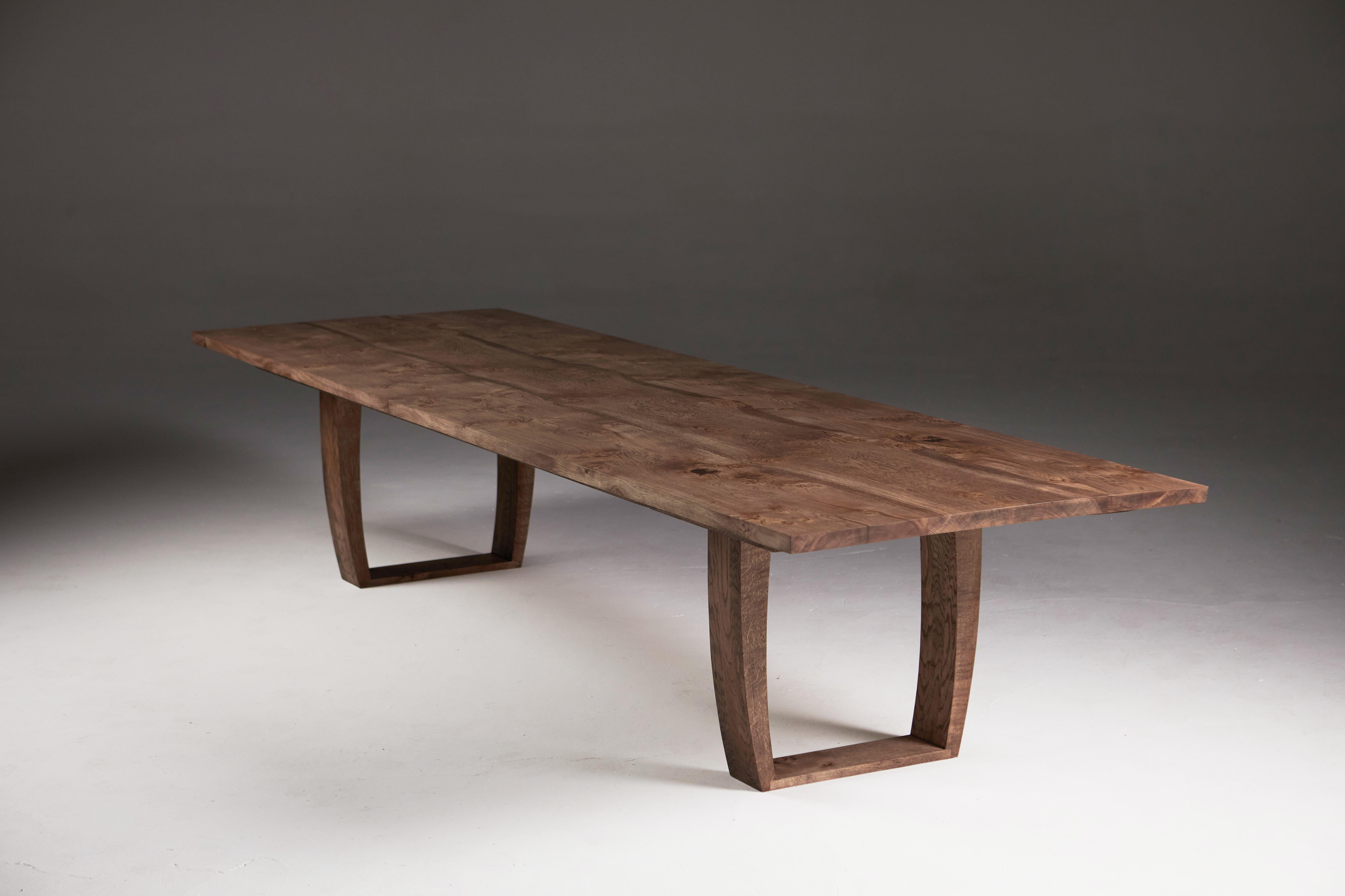 Made from two pieces of book-matched solid English oak that have been joined along the live edge with a
central infill of more oak. 
The table has a 60 cm extension at one end, but the table can be made with extensions at both ends to increase the