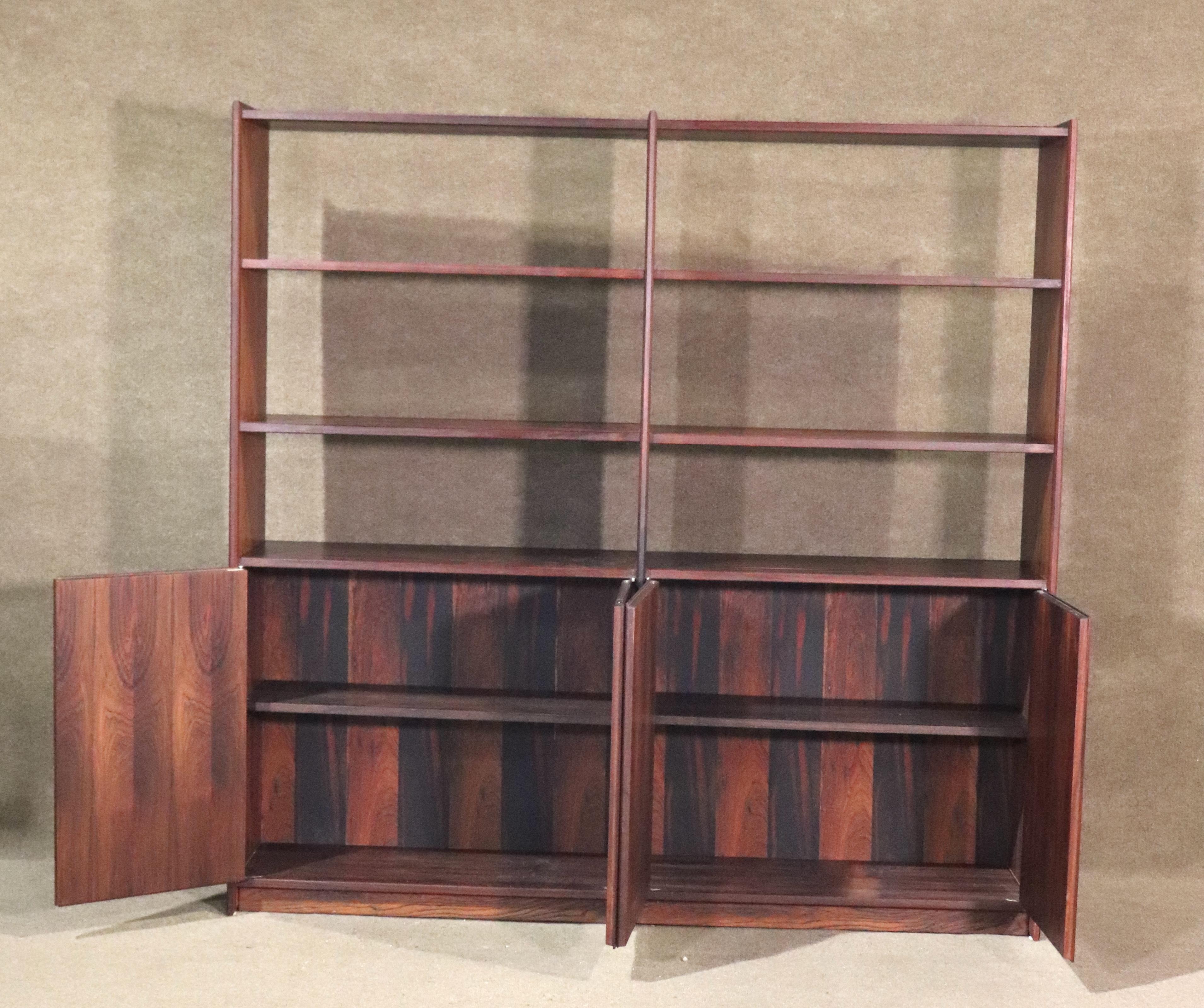 Large standing bookcase over five feet in length with rich rosewood grain. Three wide shelves on either side, and two bottom cabinets for storage. Beautiful book matched rosewood grain throughout.
Please confirm location NY or NJ