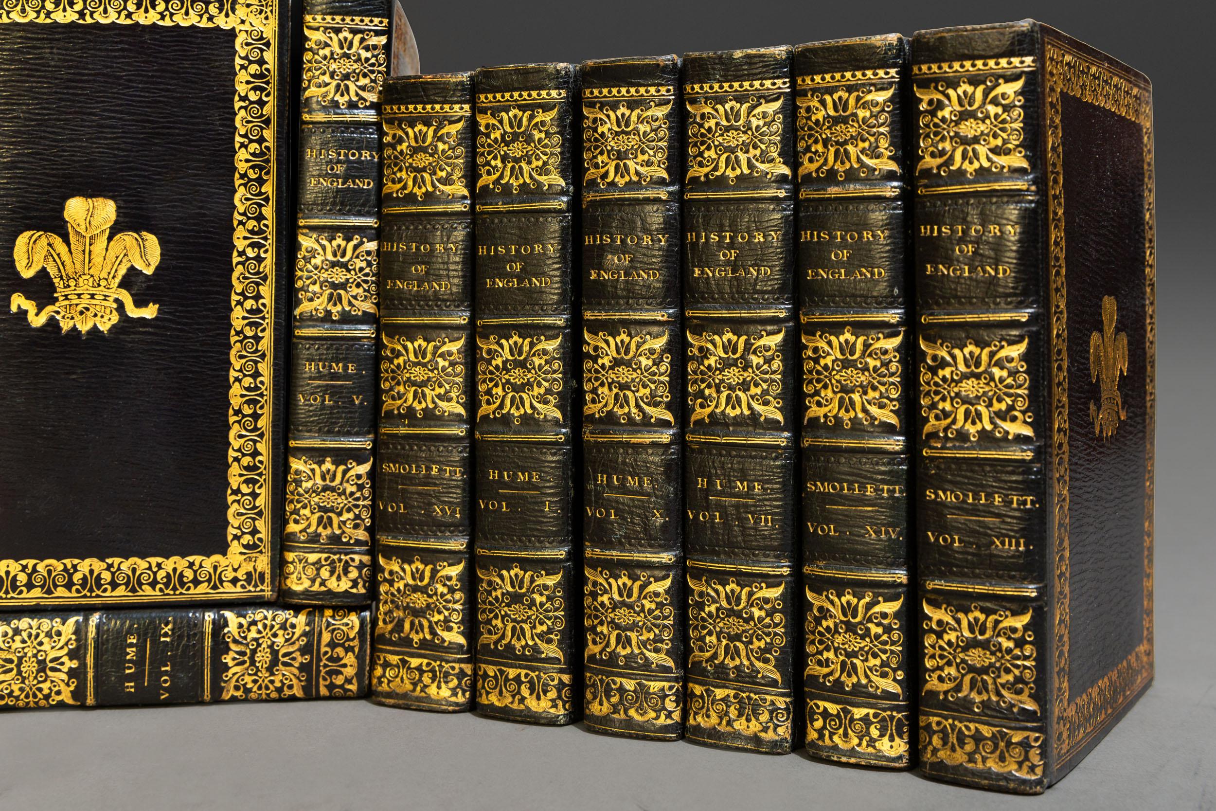 (Book Sets) 16 Volumes. David Hume & Tobias Smollett. The History Of England. Bound in full blue morocco,
all edges gilt, raised bands, ornate gilt on spines and covers, crest on front and back covers. Published:
London: Christie & Son. 1819. A