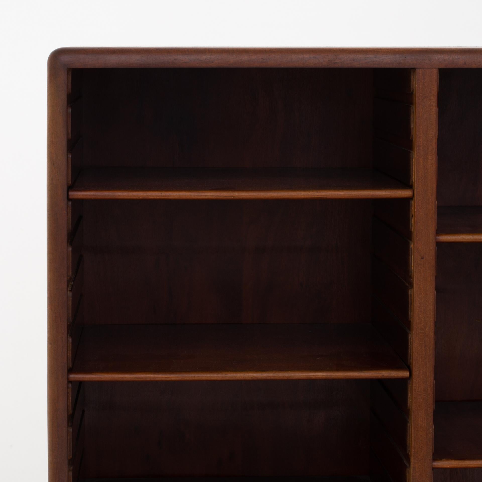 Shelf in mahogany on base with shelf tracks and 11 shelves. Design, 1937. Maker Gustav Bertelsen.