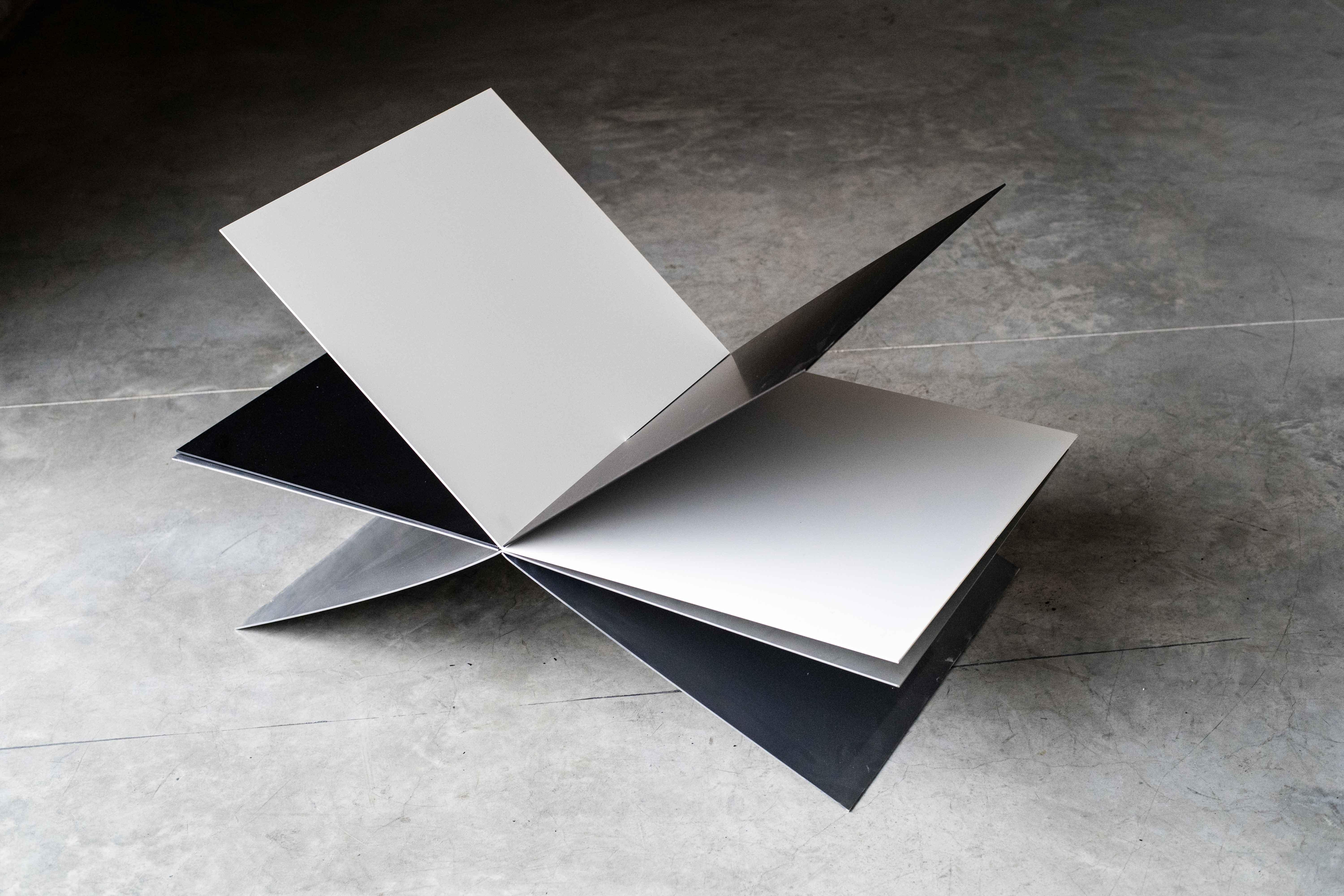 Book table by MOB 
Limited editions of 15 + 1 prototype
Designer: Fernanda Fragateiro (Portugal)
Dimensions: H 100 x D 57 x W 70 cm
Material: 10mm steel sheet, black and white powder coating, Eco-chrome painting

Thinking of a table to place