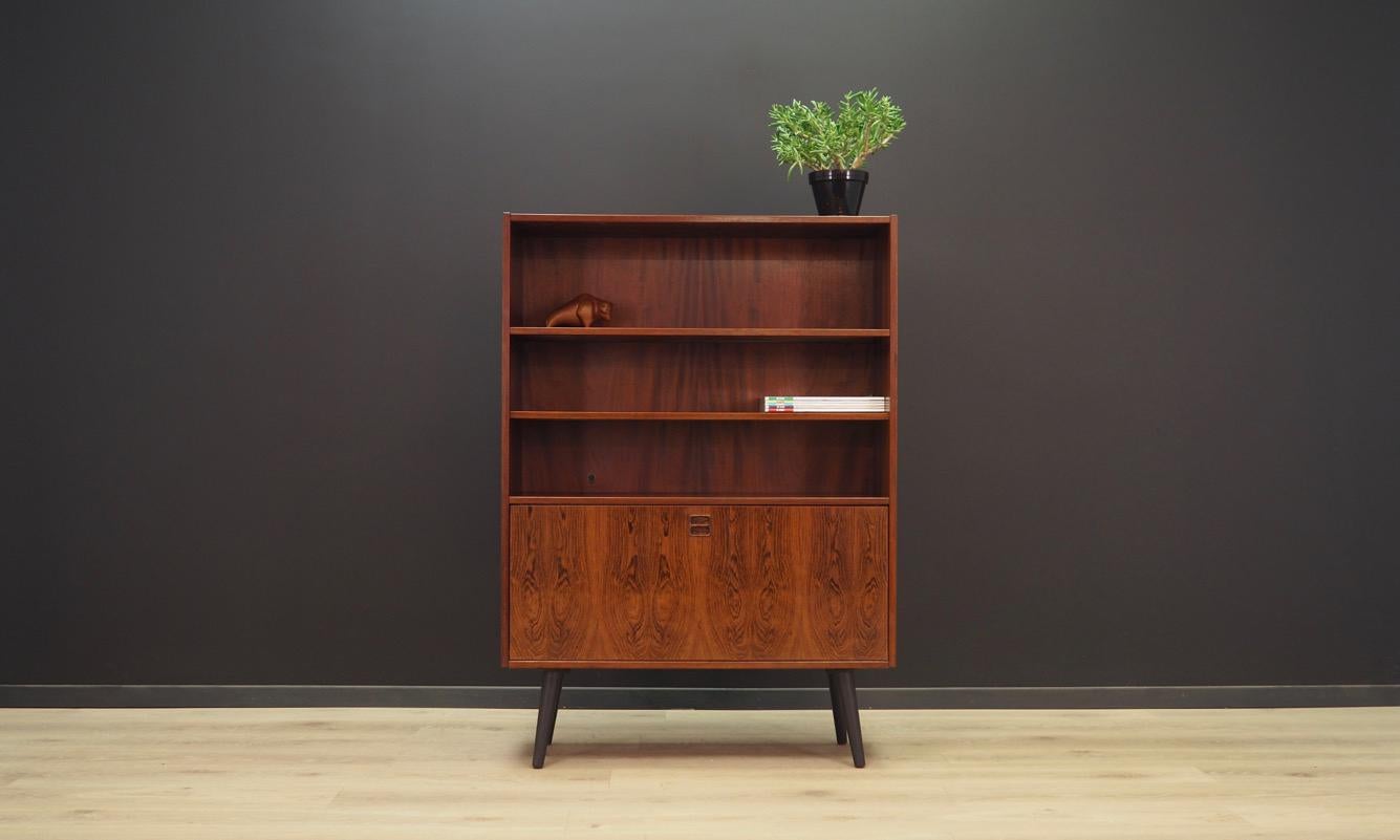 A classic bookcase from the 1960s-1970s, Danish design, minimalistic form. Furniture finished with rosewood veneer. Shelves with adjustable height. Inside the bar there are two shelves and drawers. Maintained in good condition (minor bruises and