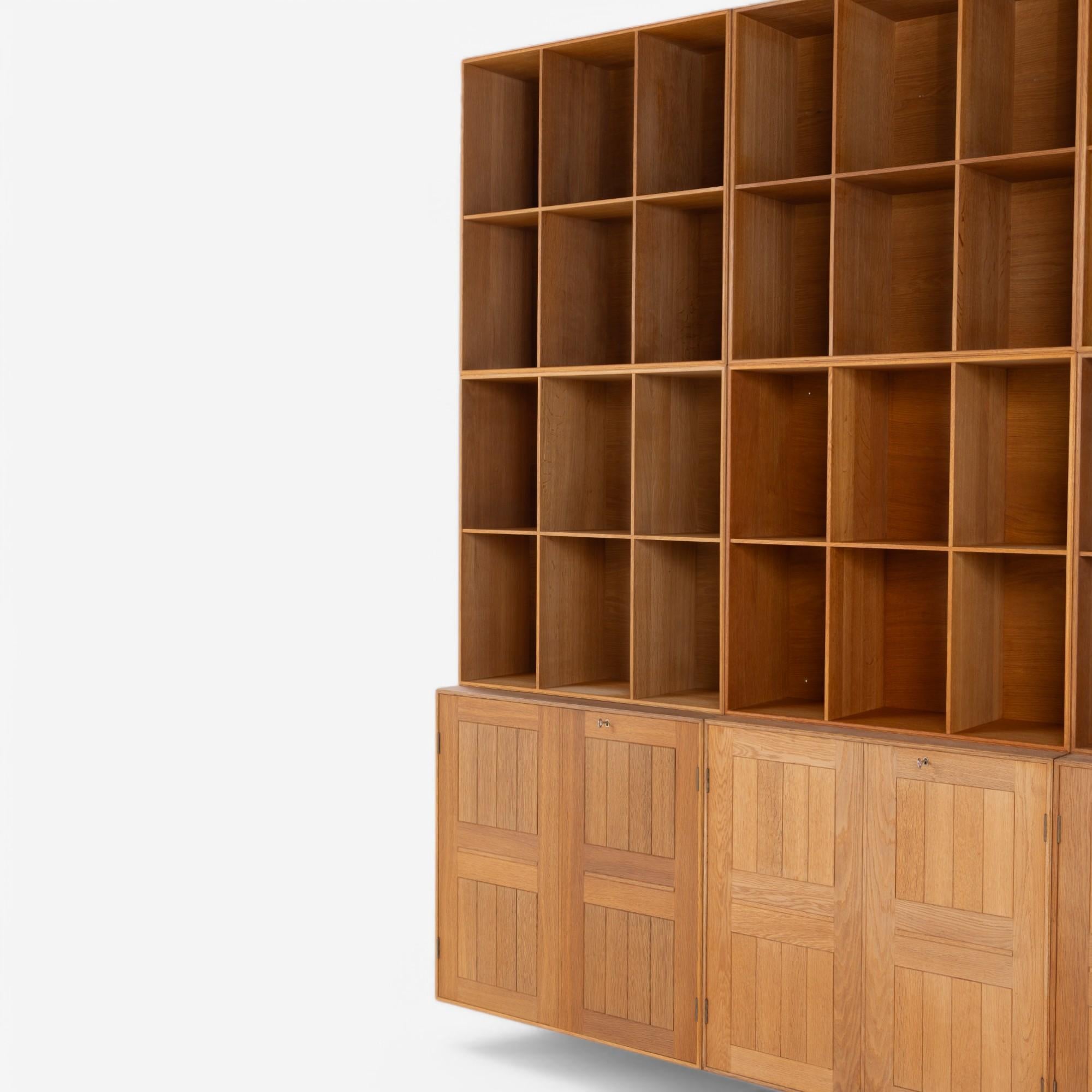 Sistema di archiviazione completo contenente tre armadi e sei librerie in rovere massiccio di Rud Rasmussen Snedkerier, su design di Mogens Koch.