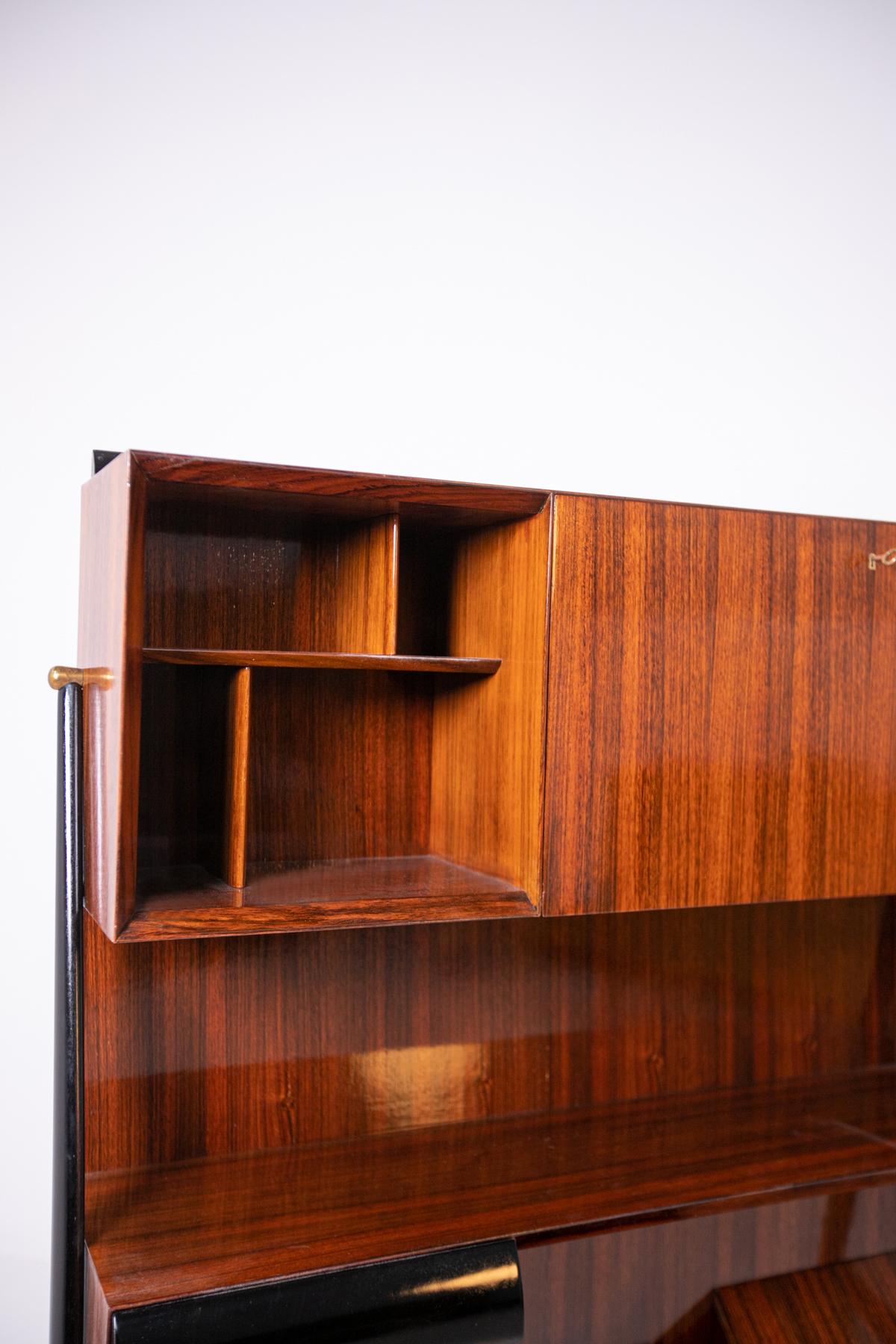 Bookcase attributed to Ico Parisi inwood and ebonized wood, 1950s.
The elegant bookcase has a Dual function it can also serve as a sideboard or closet. Made of wood and high quality ebonized wood, the bookcase has several compartments, shelves and