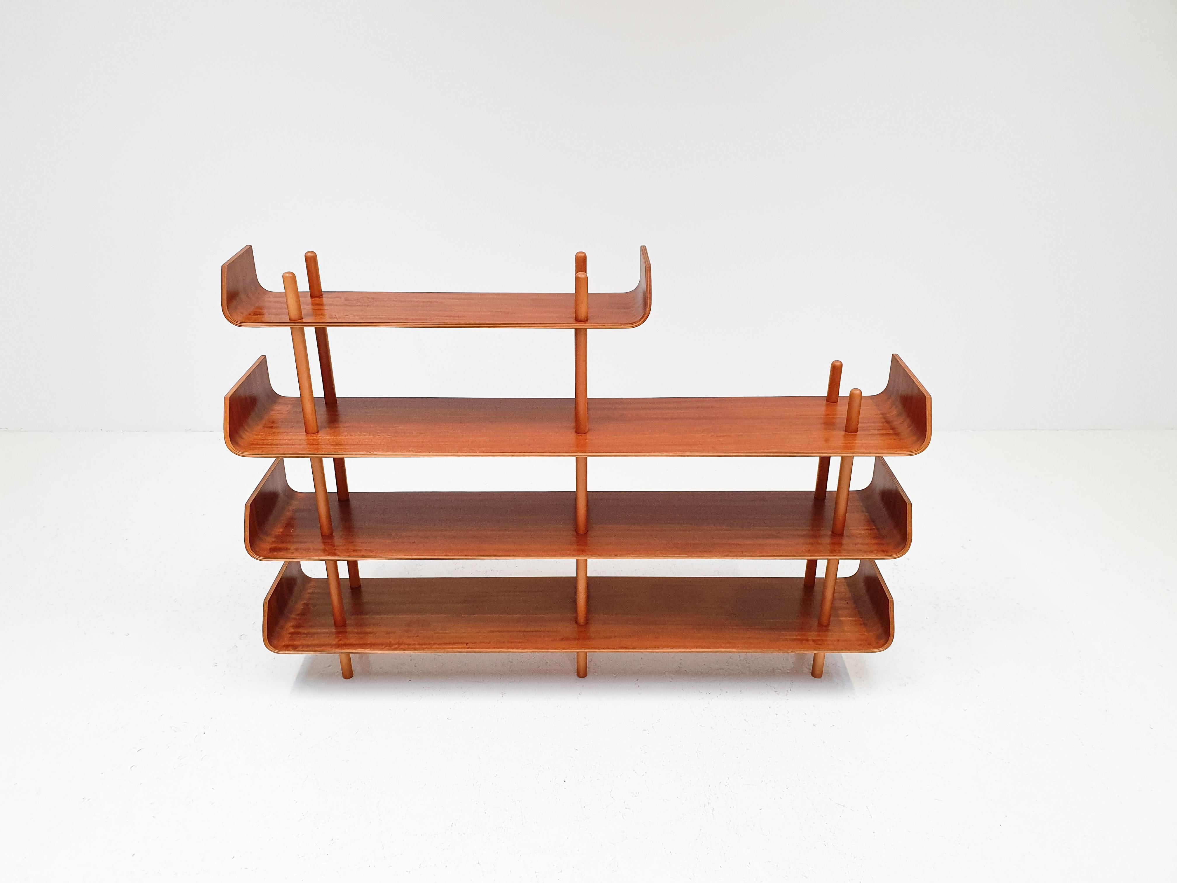 A plywood shelving unit by Willem Lutjens for De Boer Gouda, with the characteristic curved ends of the shelves which has made this such a famous and now rare design. The piece was designed in 1953 and manufactured in the Netherlands.

The